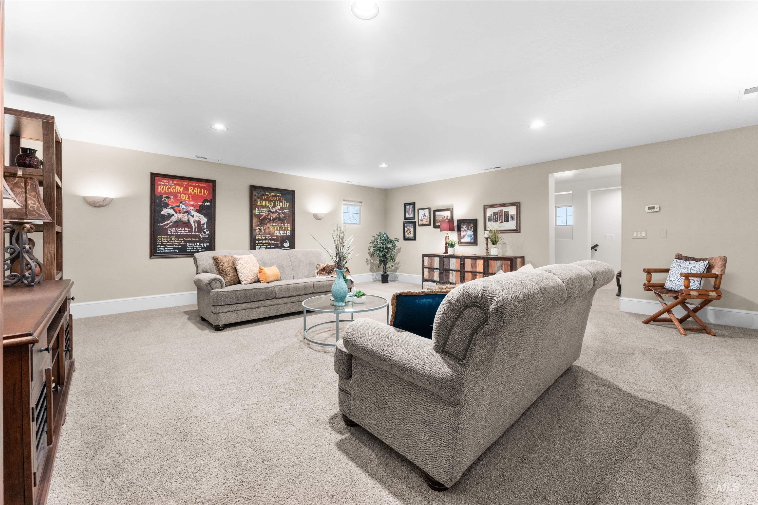 Living room with light colored carpet and recessed lighting