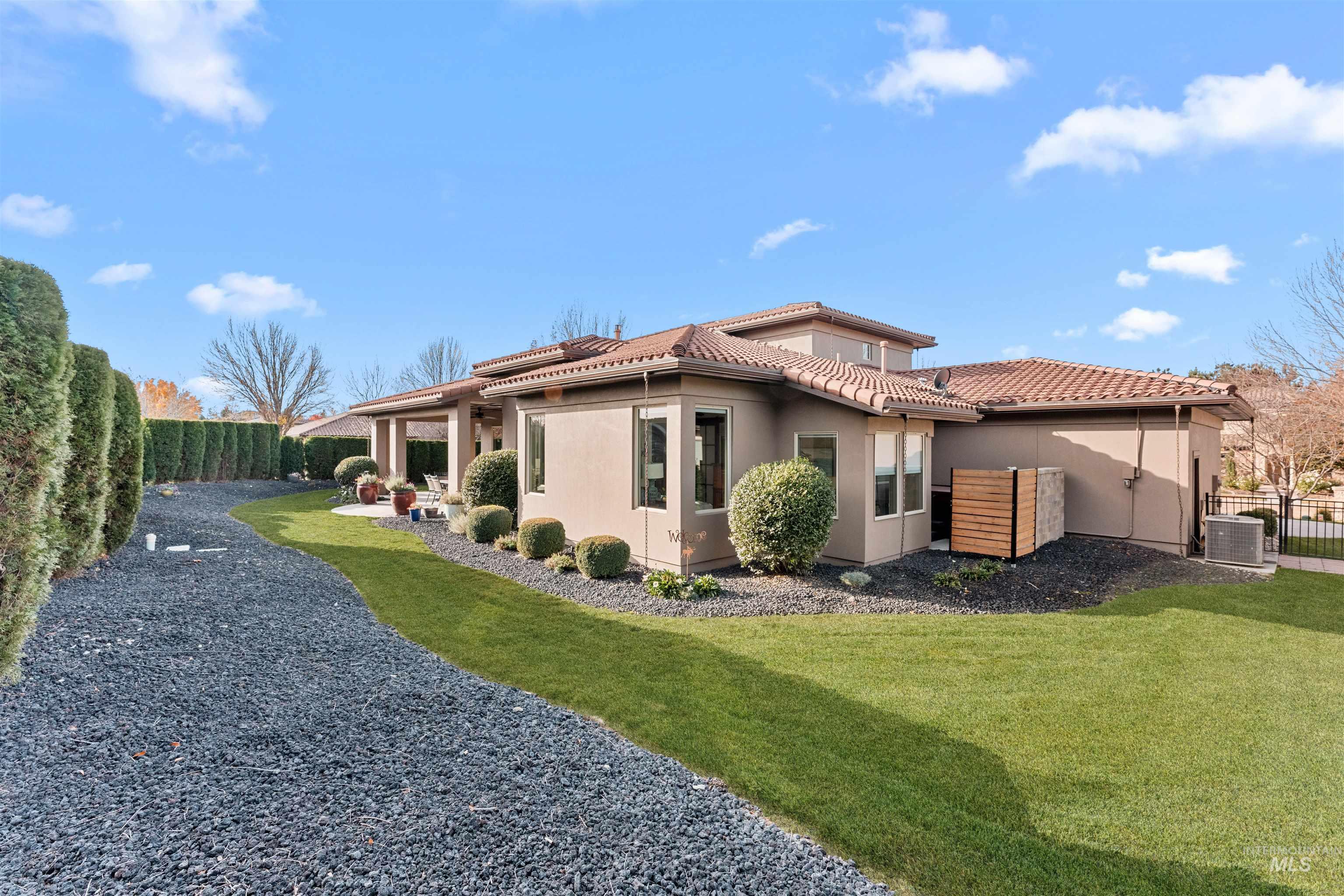 View of home's exterior with a fenced backyard, stucco siding, a patio, and a tiled roof