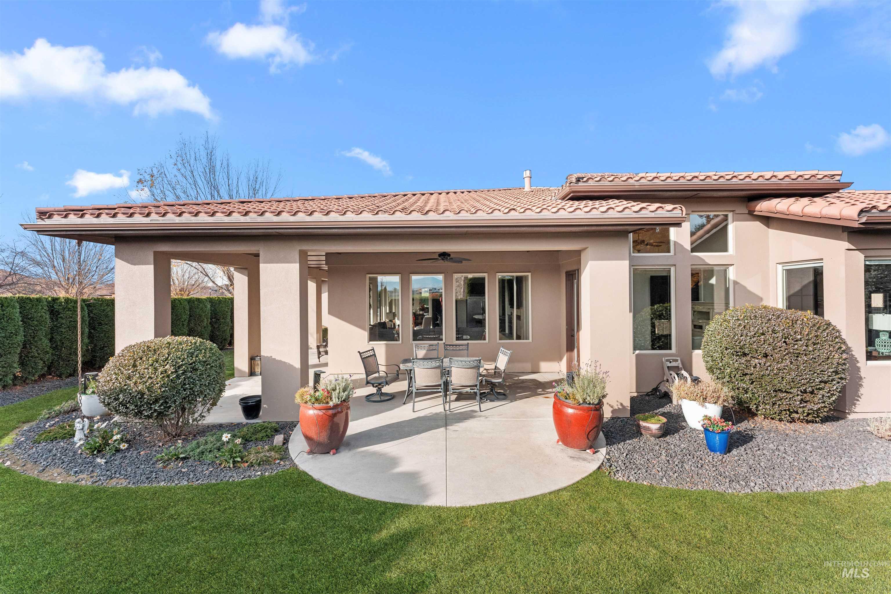 Back of property featuring ceiling fan, a patio, and stucco siding
