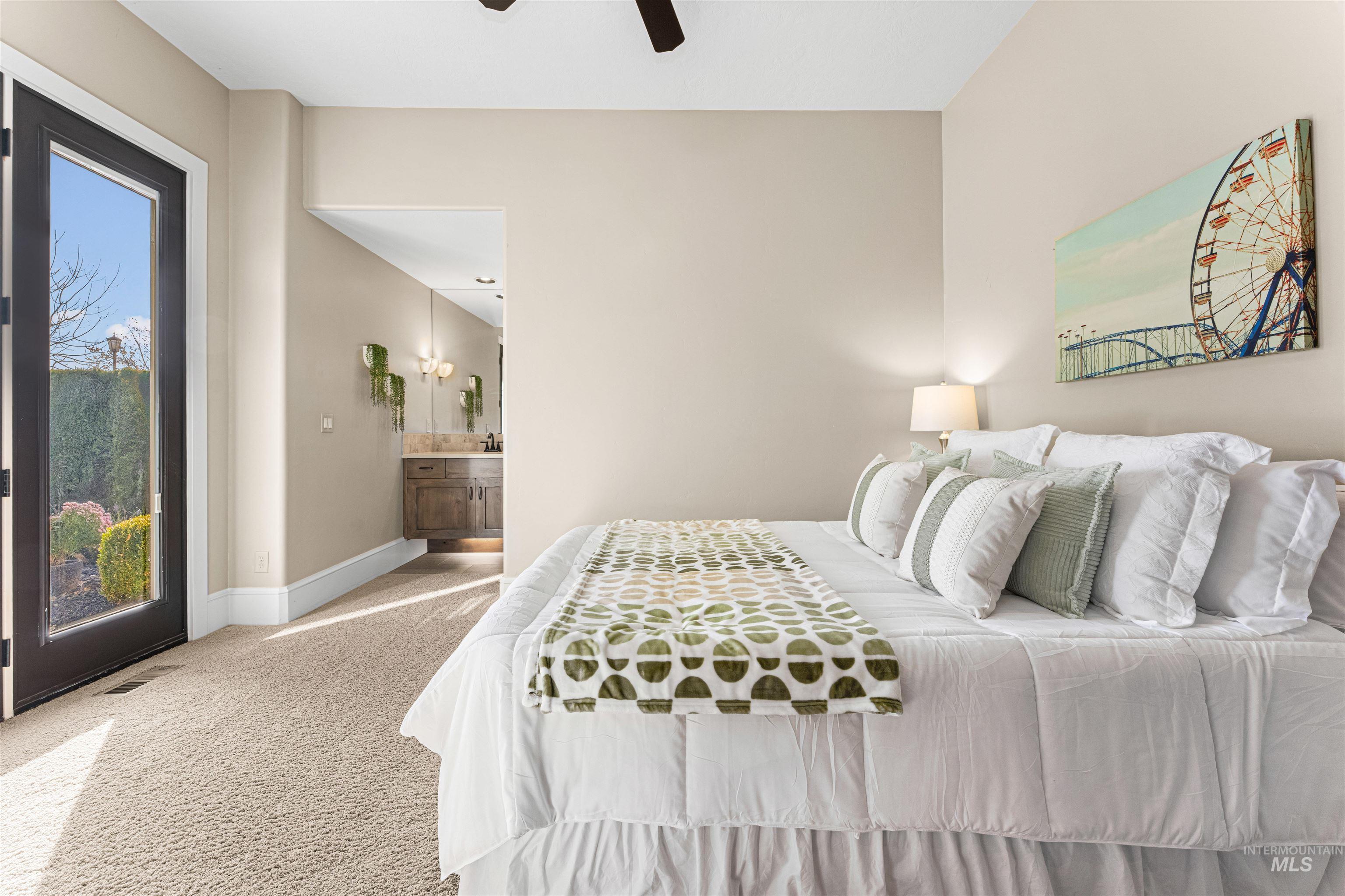 Bedroom featuring carpet floors, access to outside, ensuite bath, and ceiling fan
