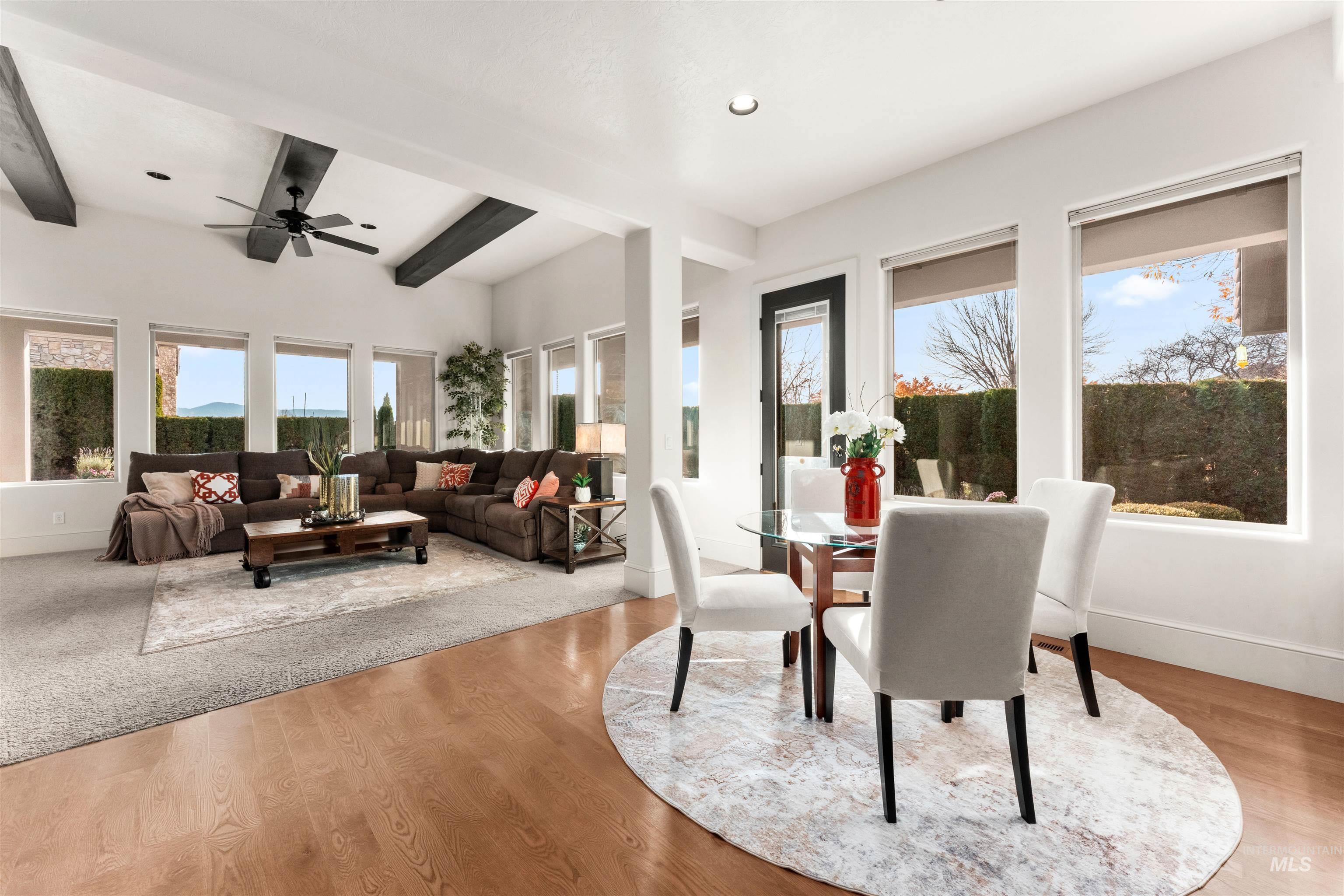 Dining space with beam ceiling, light wood-style flooring, and recessed lighting