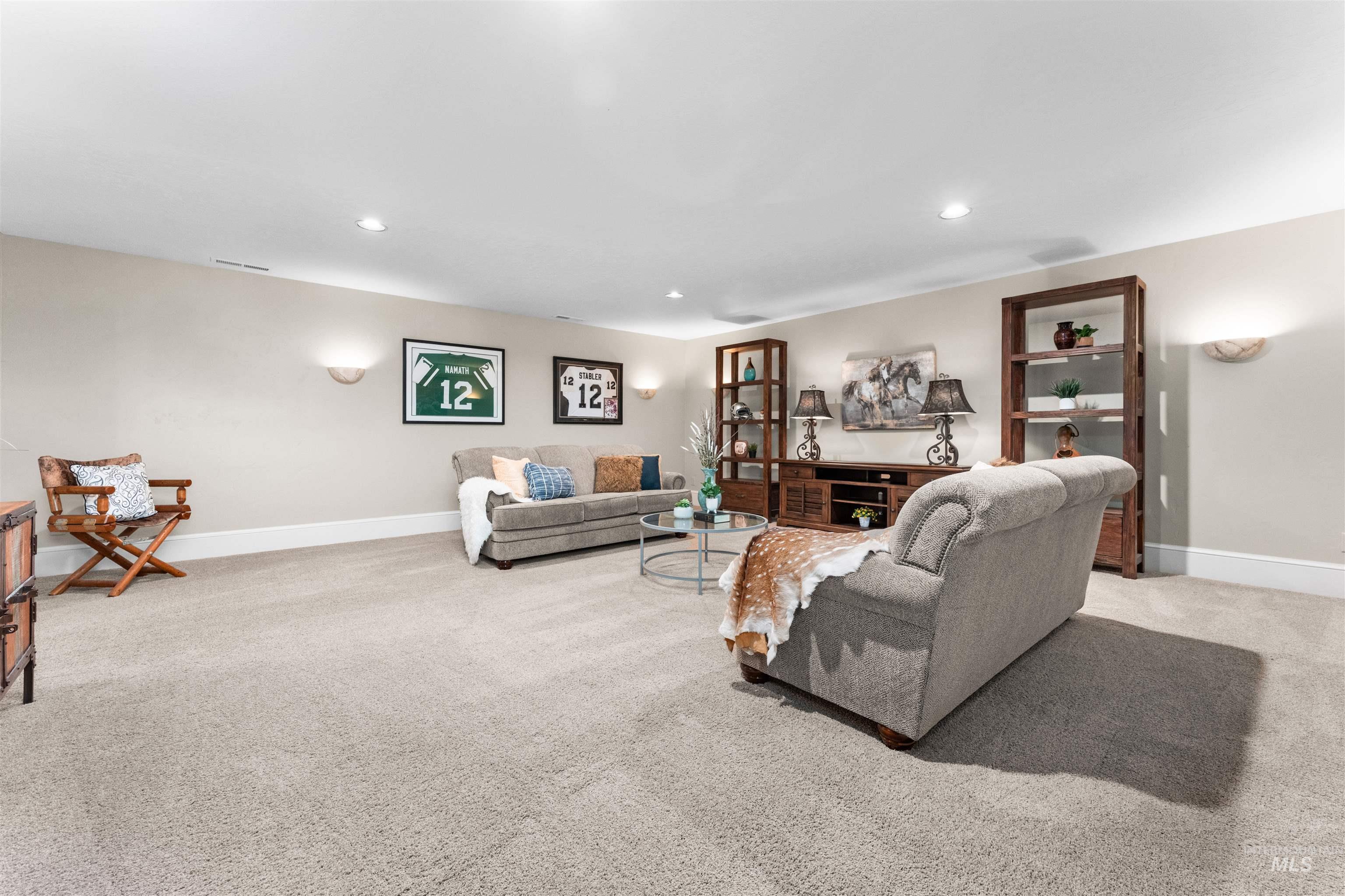 Living area featuring light carpet and recessed lighting