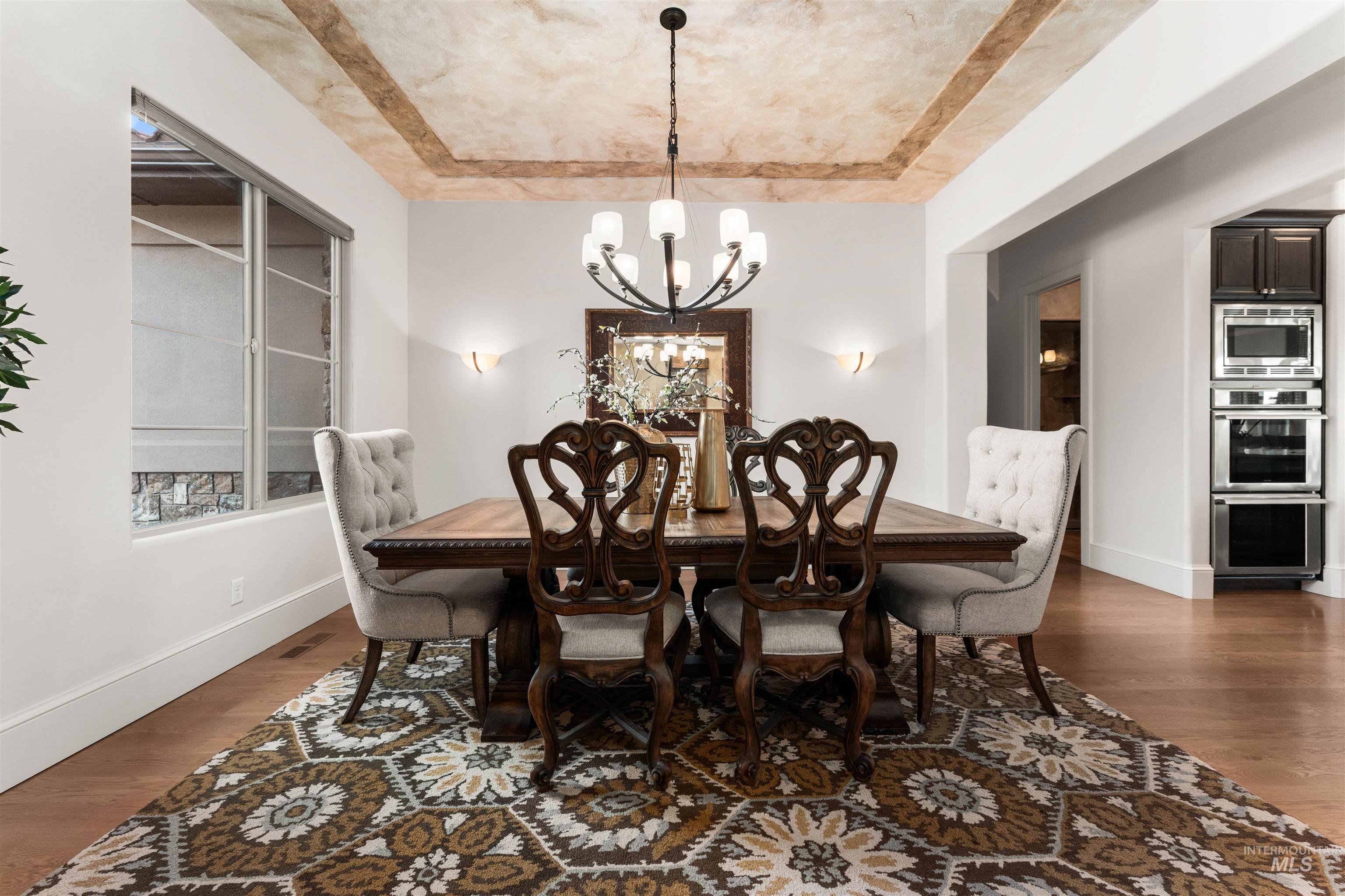 Dining room featuring dark wood finished floors and a chandelier