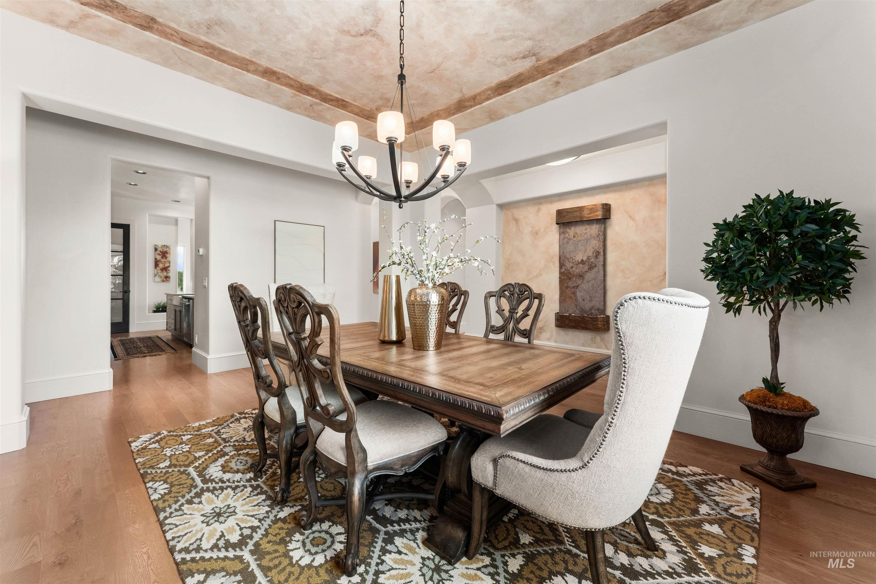 Dining room with light wood finished floors and a chandelier