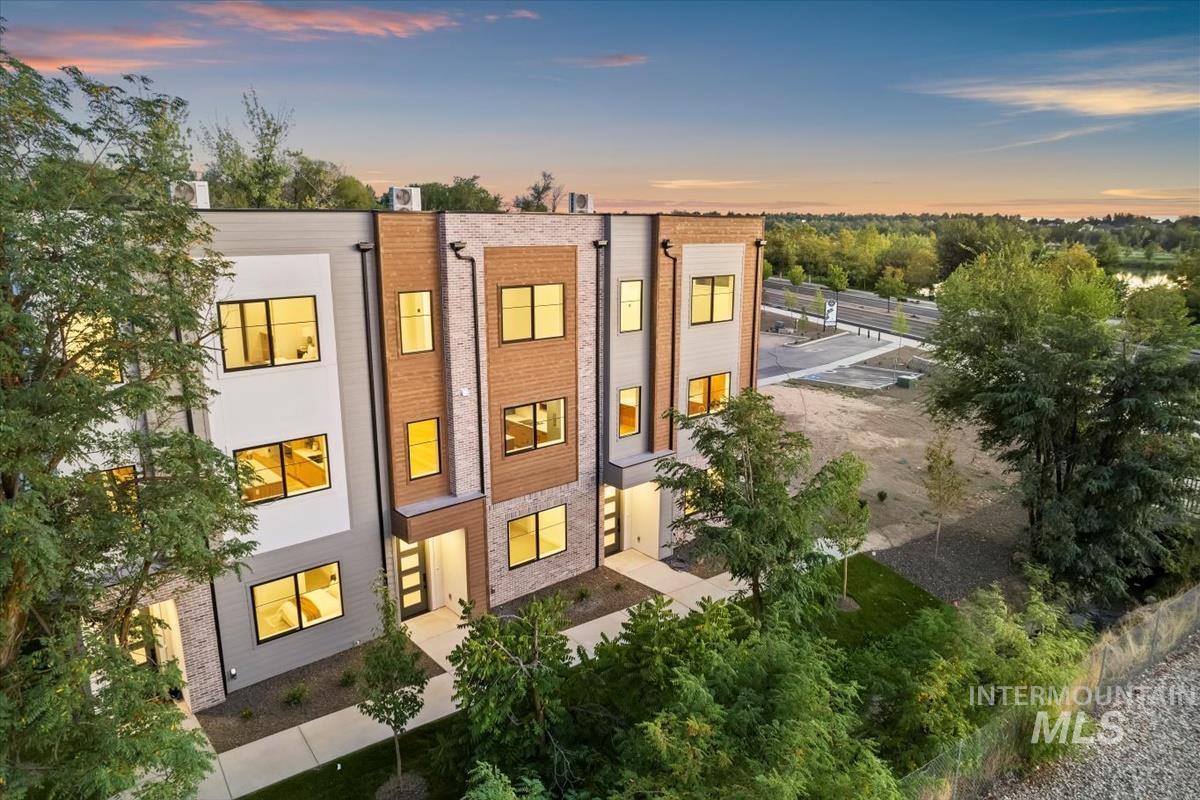 View of back of property at dusk