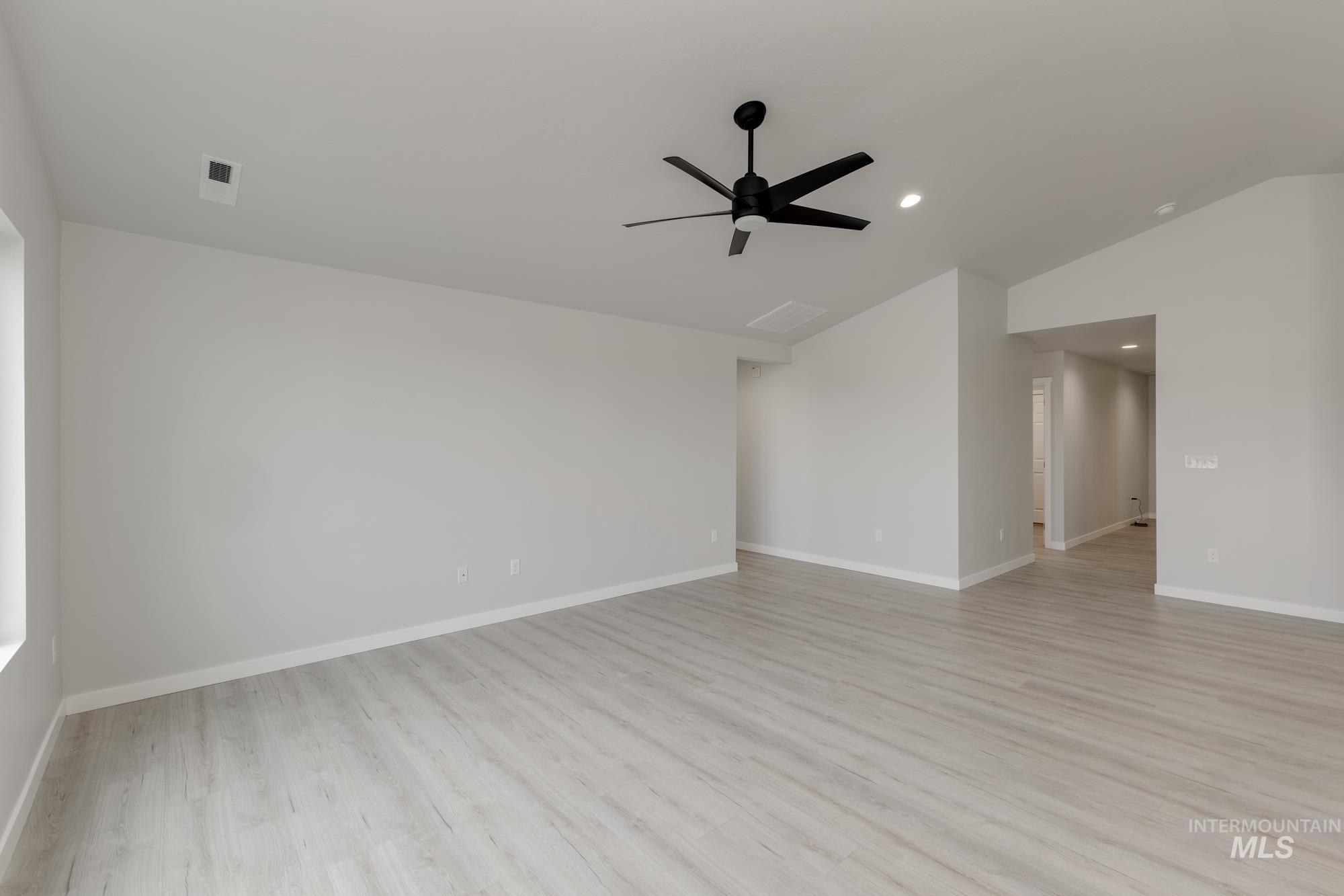 Unfurnished room with light wood finished floors, lofted ceiling, recessed lighting, and ceiling fan