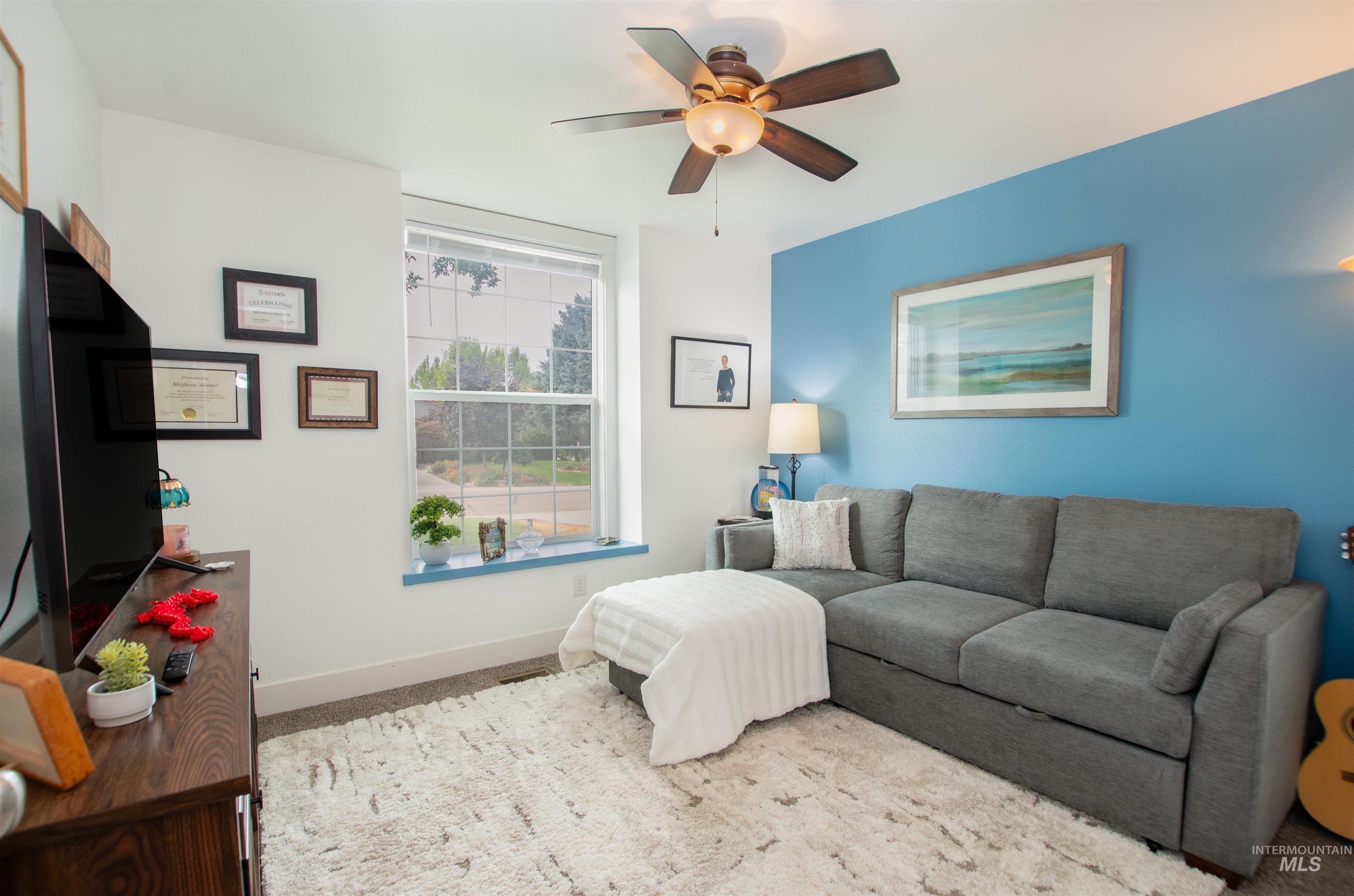 Carpeted bedroom with baseboards and ceiling fan