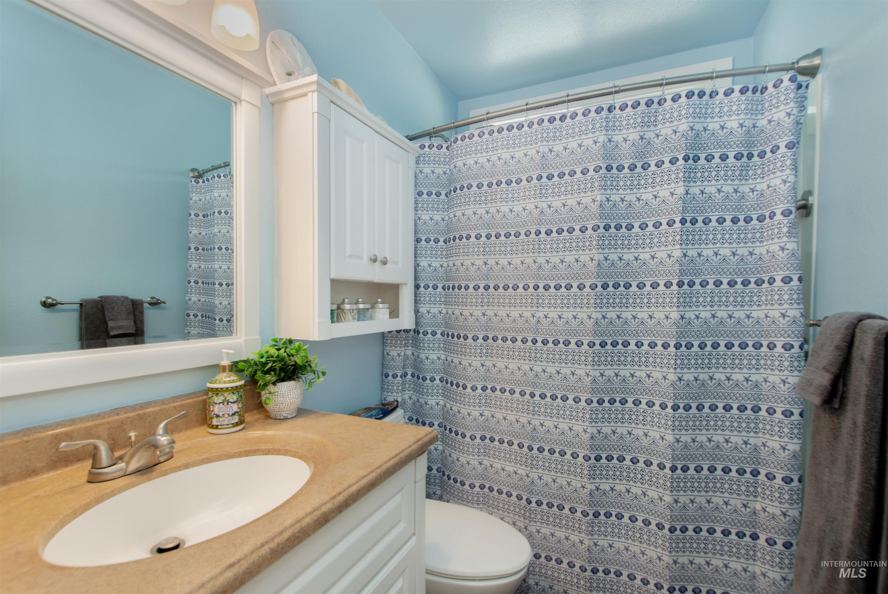 Bathroom with vanity and a shower with shower curtain