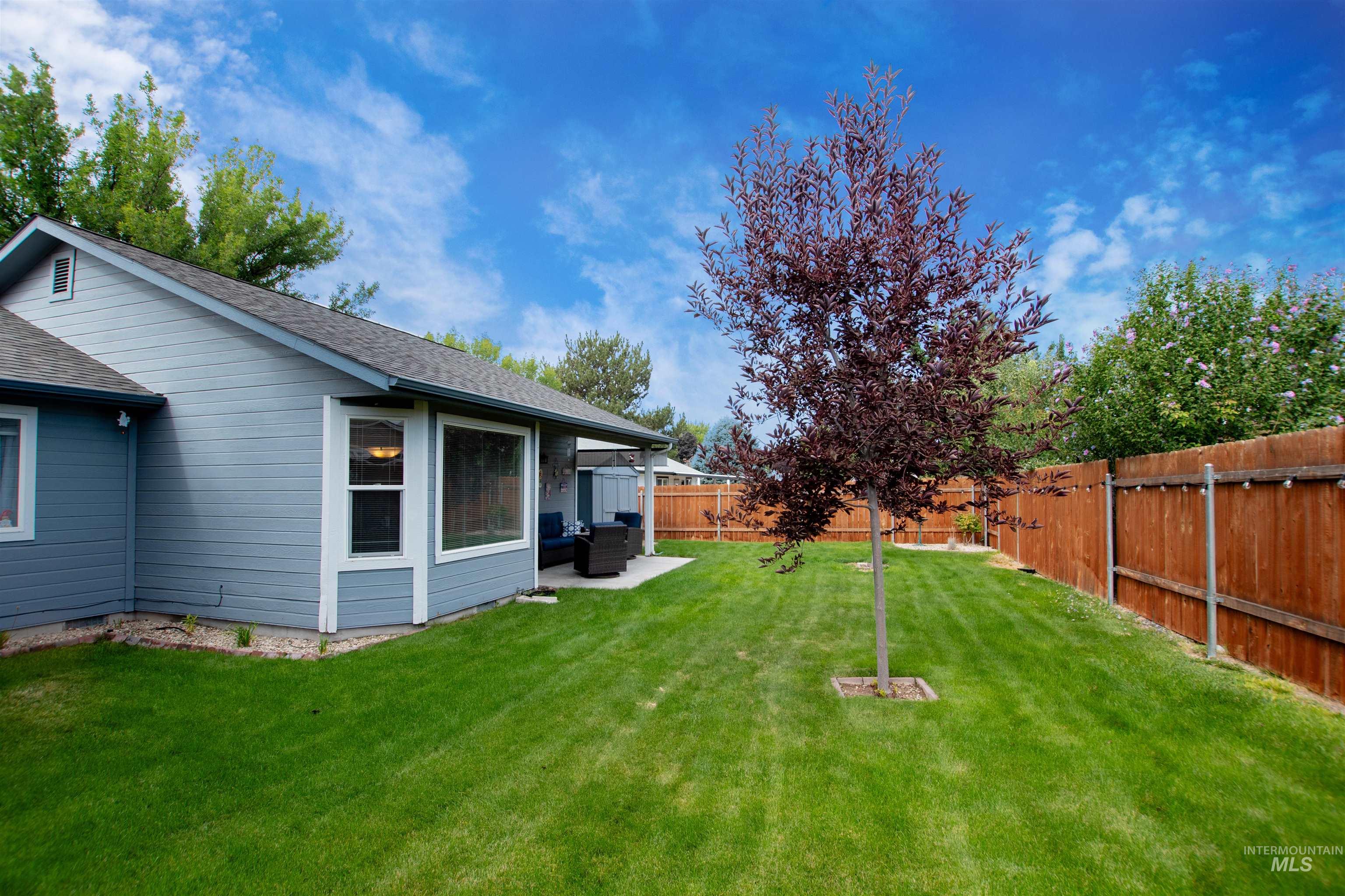 Fenced backyard with a patio