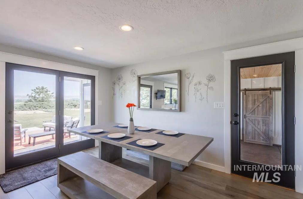 Dining room featuring wood finished floors, plenty of natural light, and recessed lighting