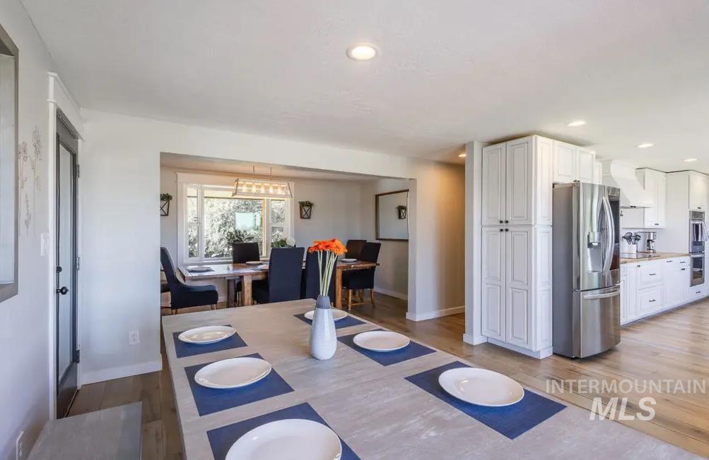 Dining space featuring light wood-style flooring and recessed lighting