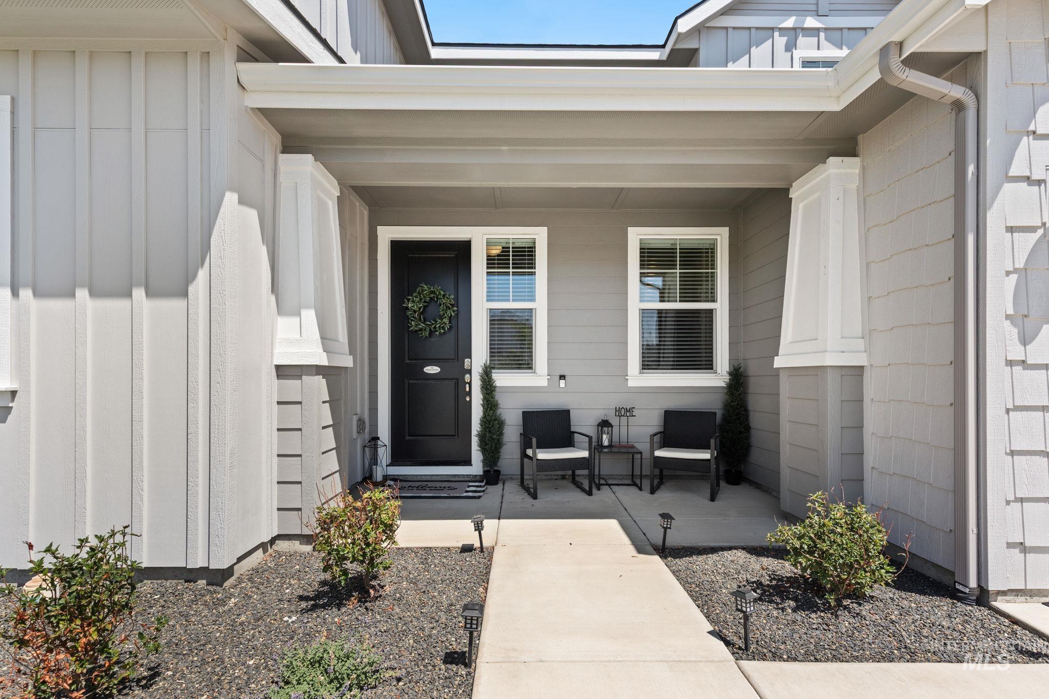 Doorway to property featuring board and batten siding and a porch