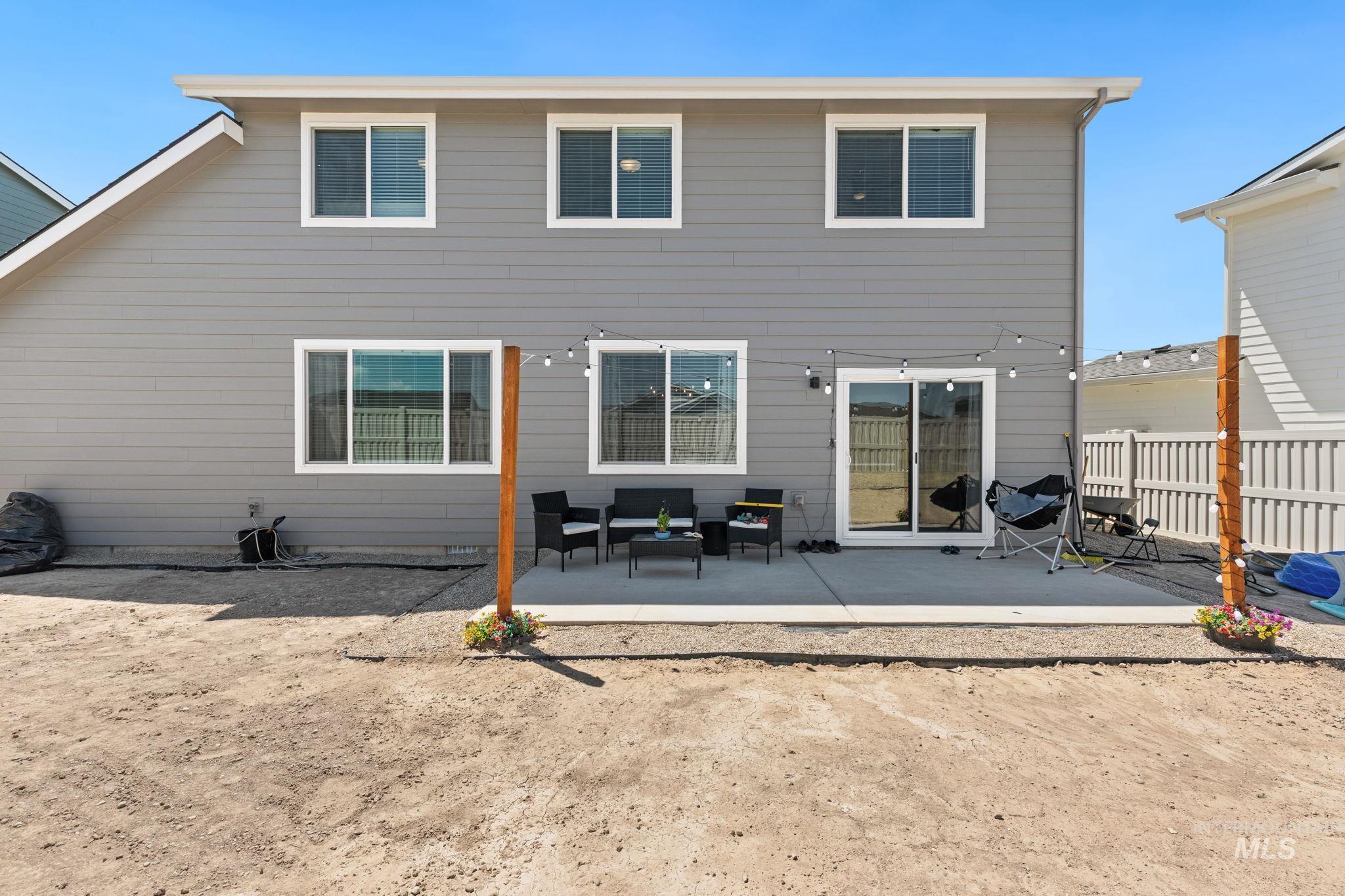 Rear view of house with an outdoor living space and a patio area