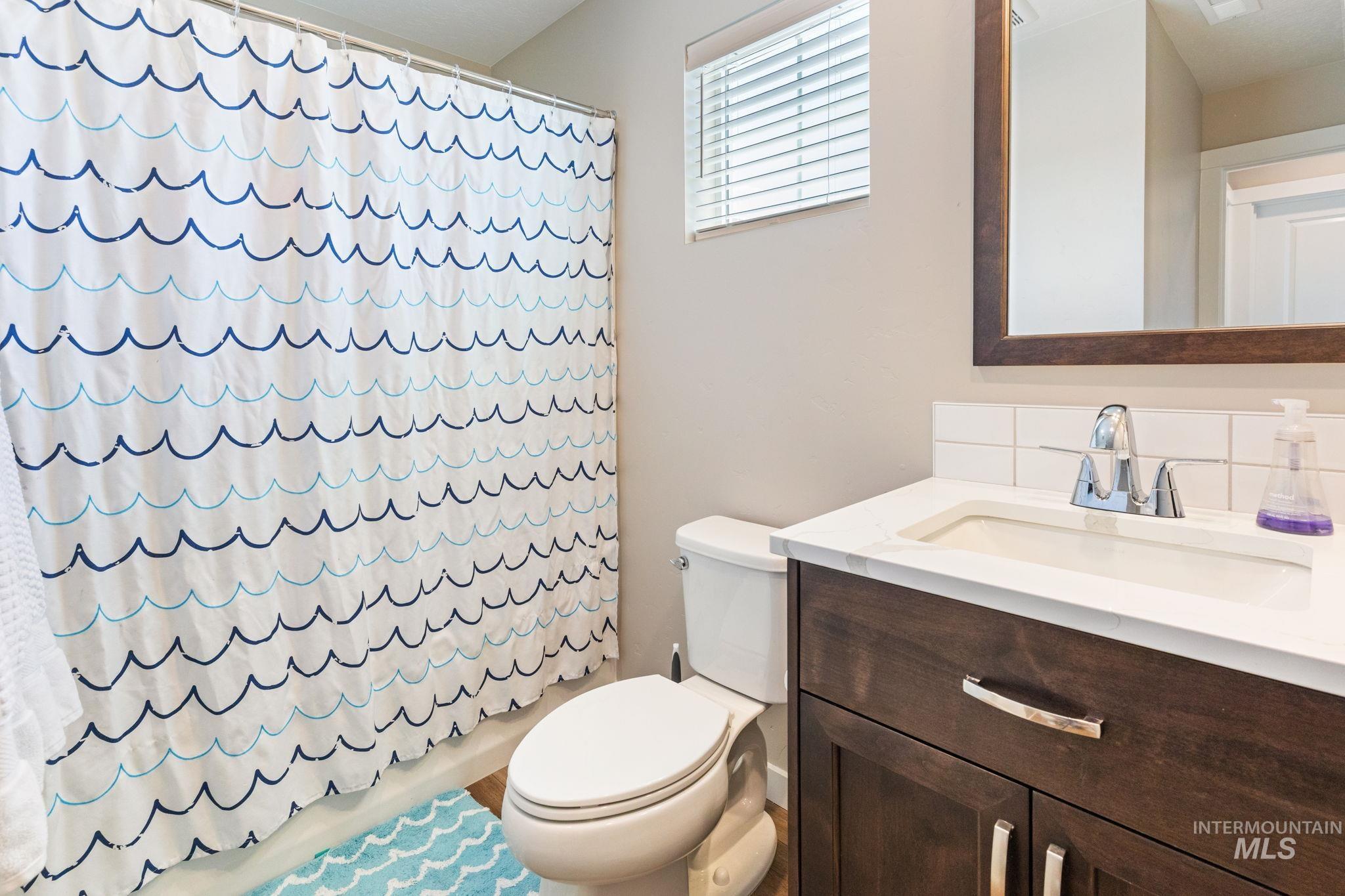 Full bathroom with vanity and shower / tub combo