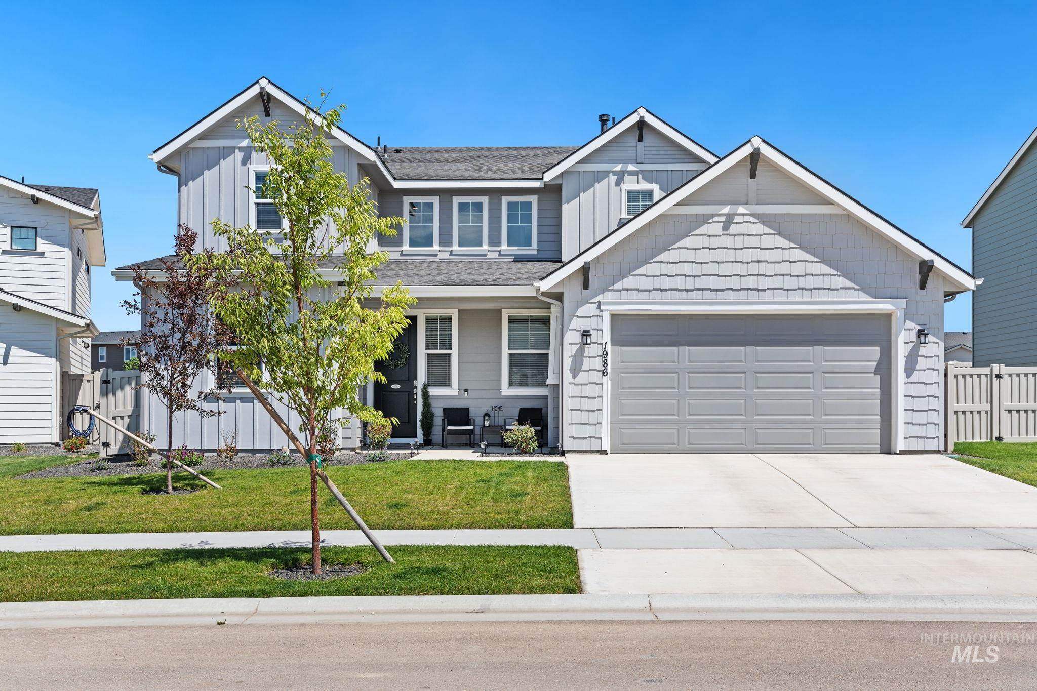 Craftsman house featuring board and batten siding, a garage, and driveway