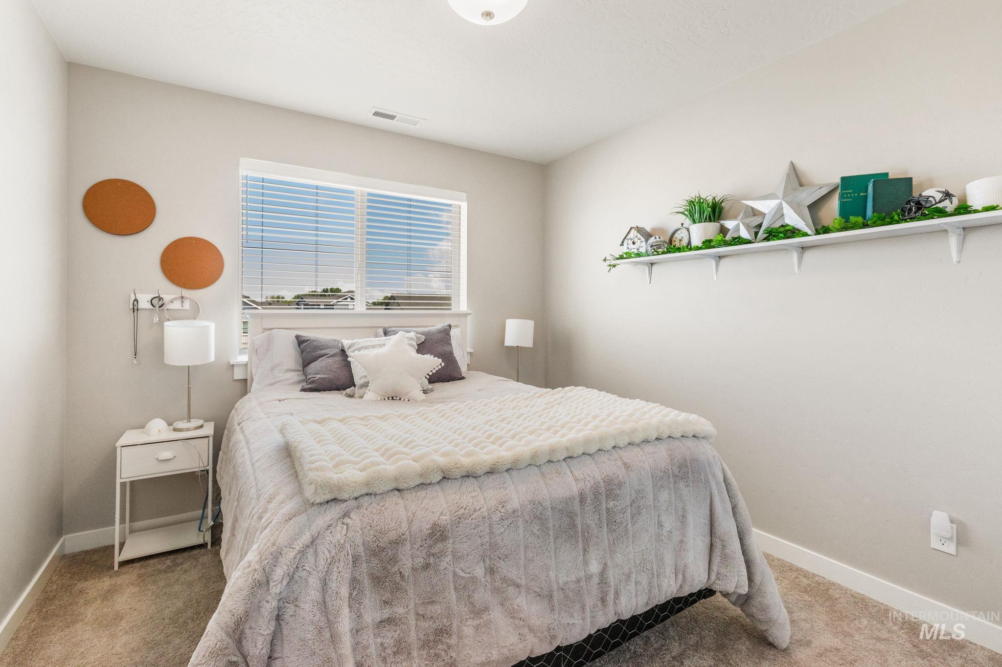 Bedroom with baseboards and carpet