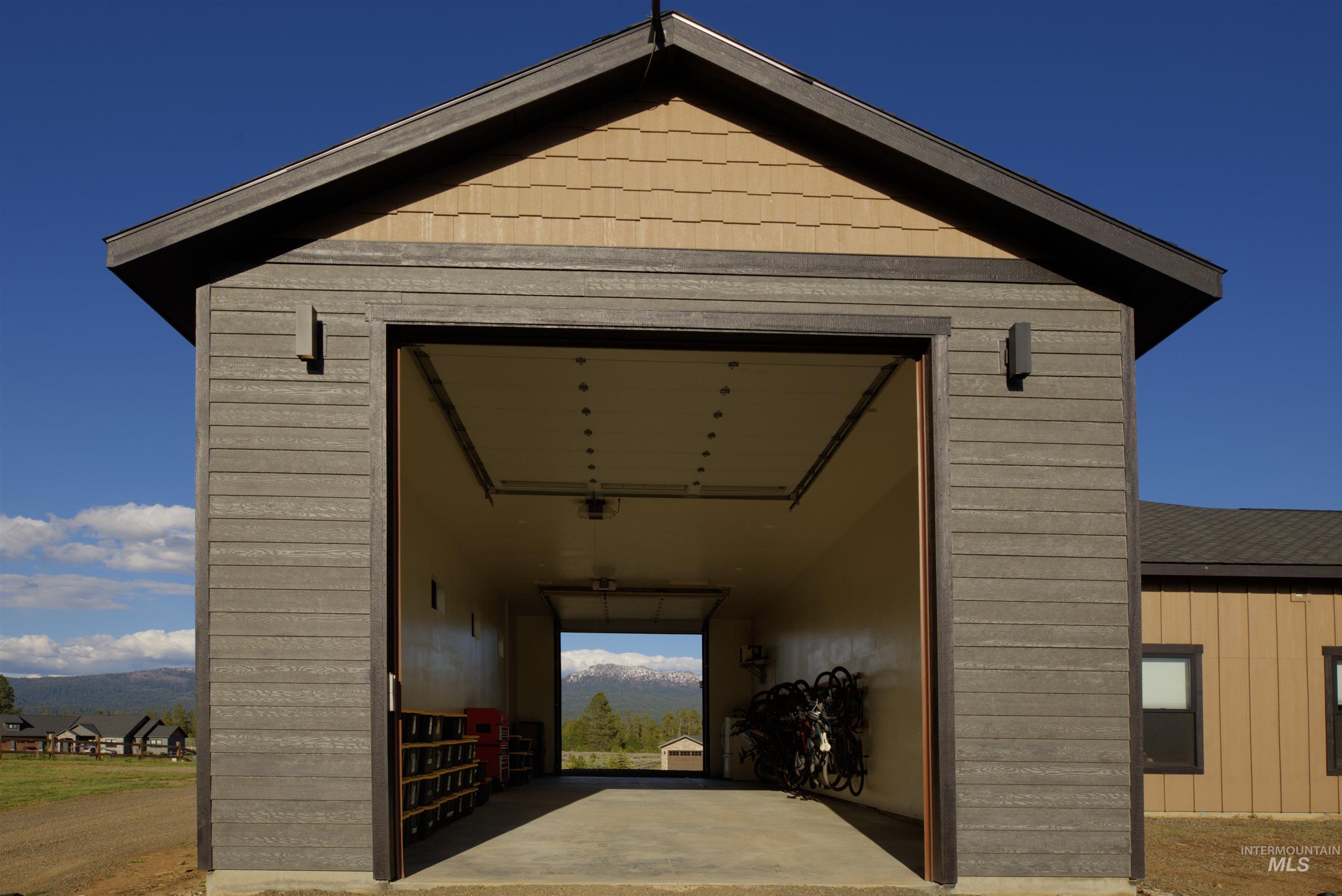 Gable-roofed outbuilding with horizontal siding and accent shingles