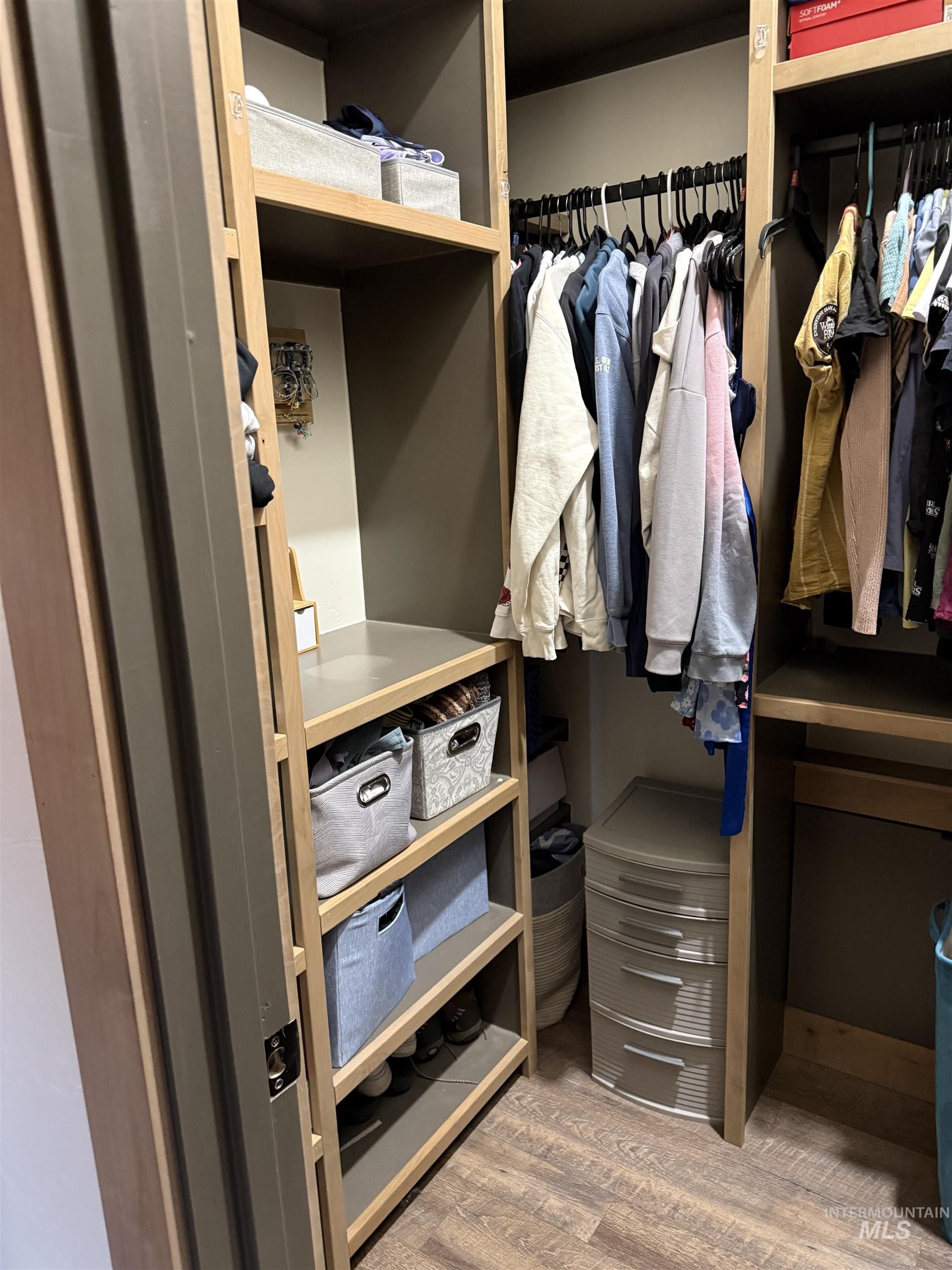Custom closet system featuring wood-finish shelving and built-in hanging rods