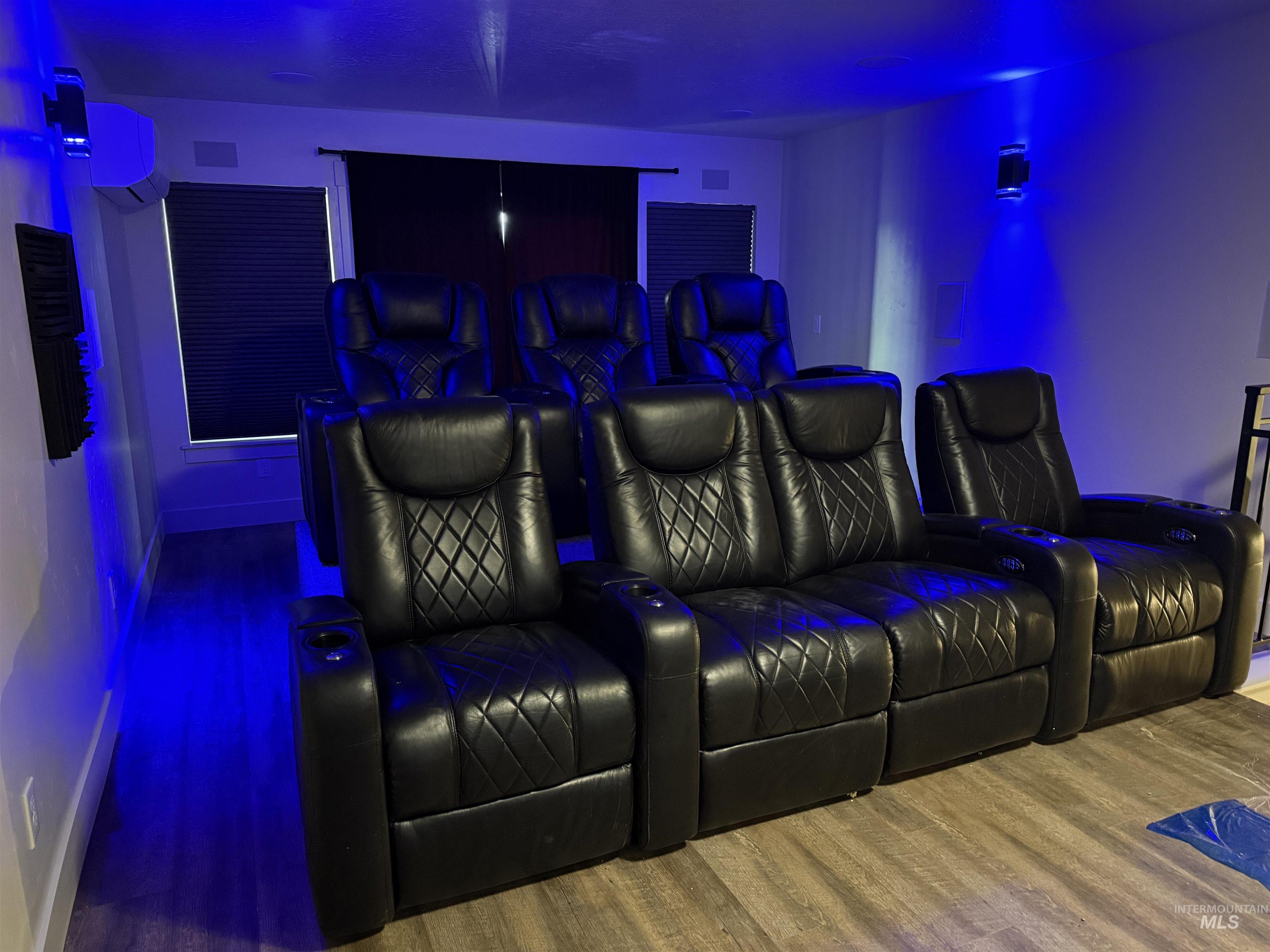 Dedicated media room featuring tiered seating with multiple rows of black upholstered recliners