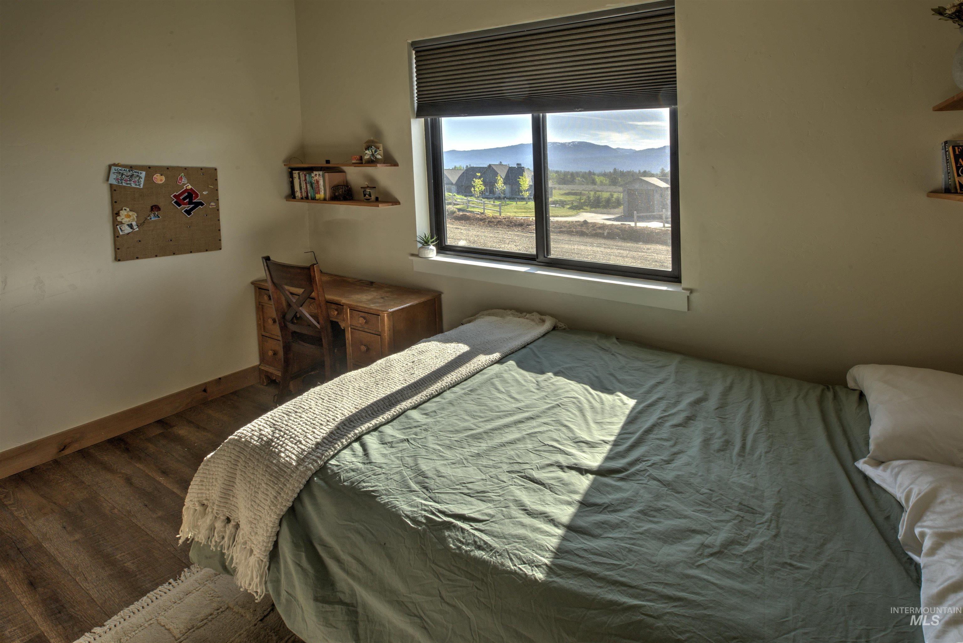 Window framing distant mountains and pastoral scenery