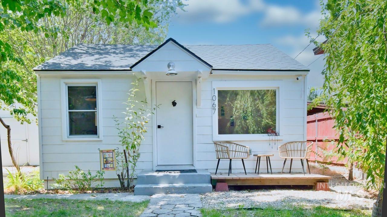 View of front of home featuring a shingled roof