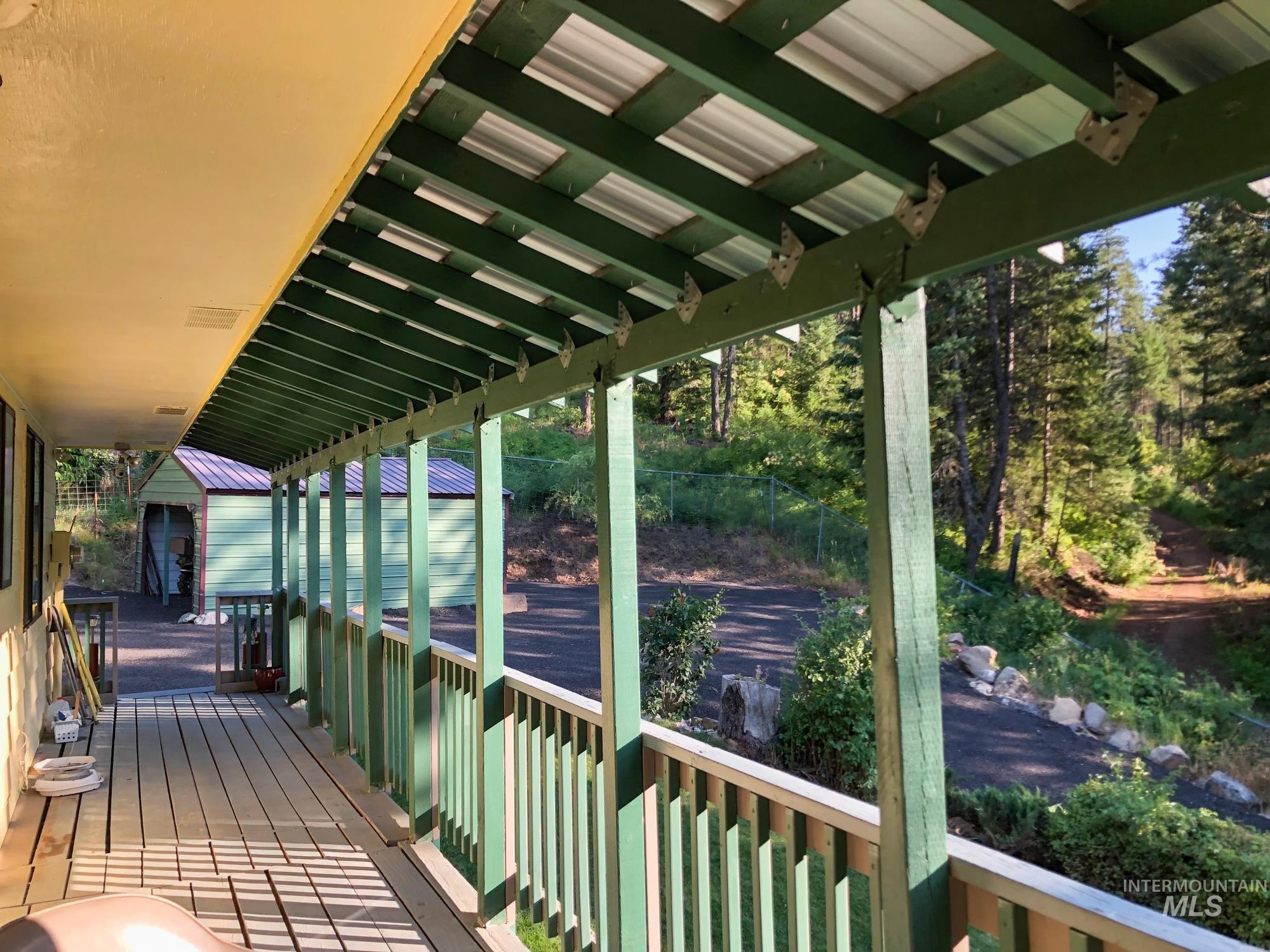 Deck featuring a shed