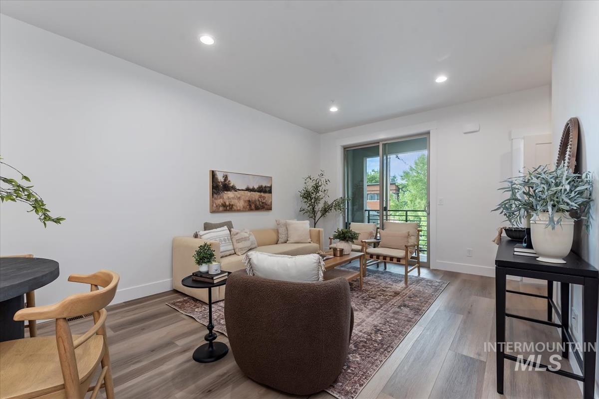 Sitting room with wood finished floors and recessed lighting