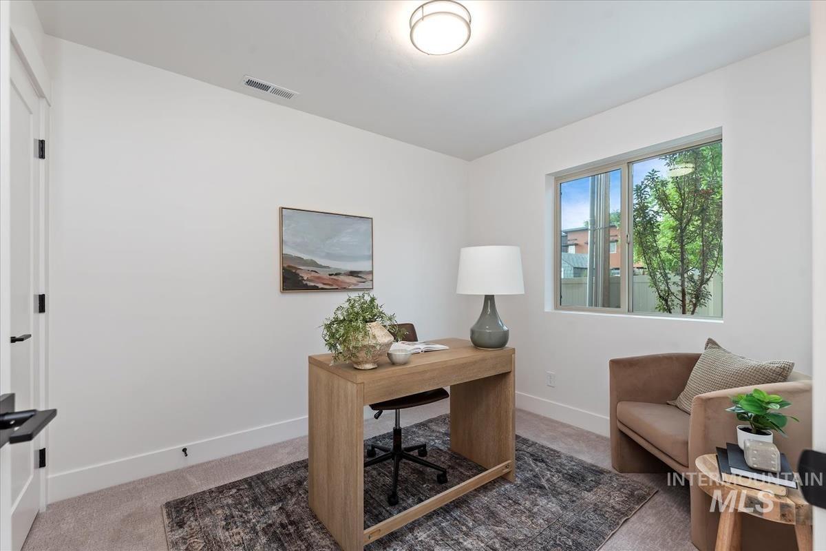 Home office with light carpet