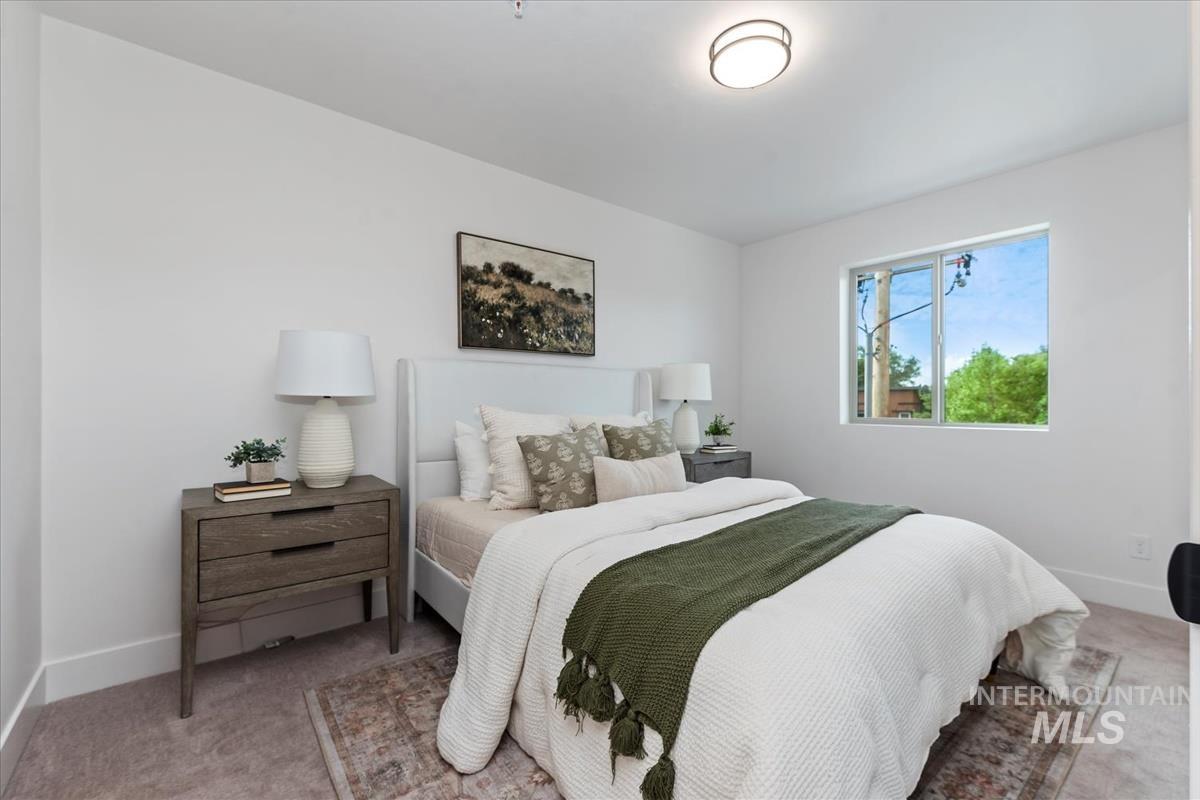 Bedroom featuring carpet floors and baseboards