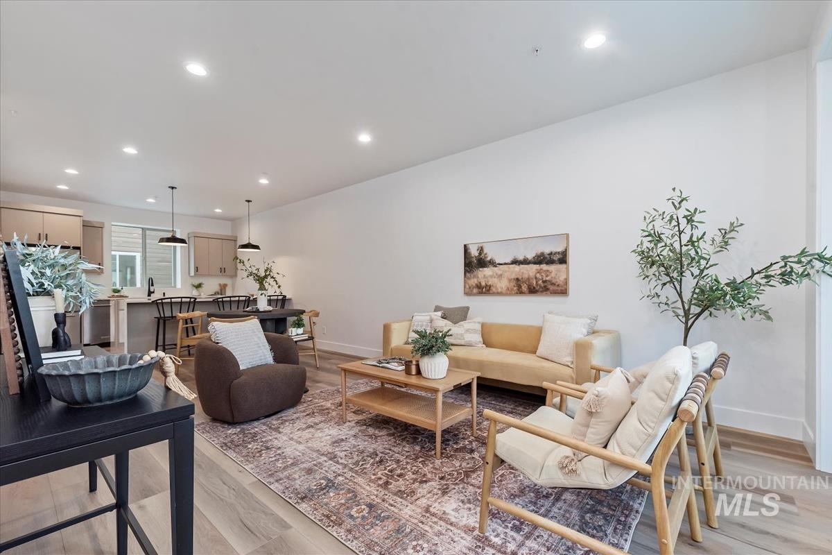 Living room with recessed lighting and light wood-style floors