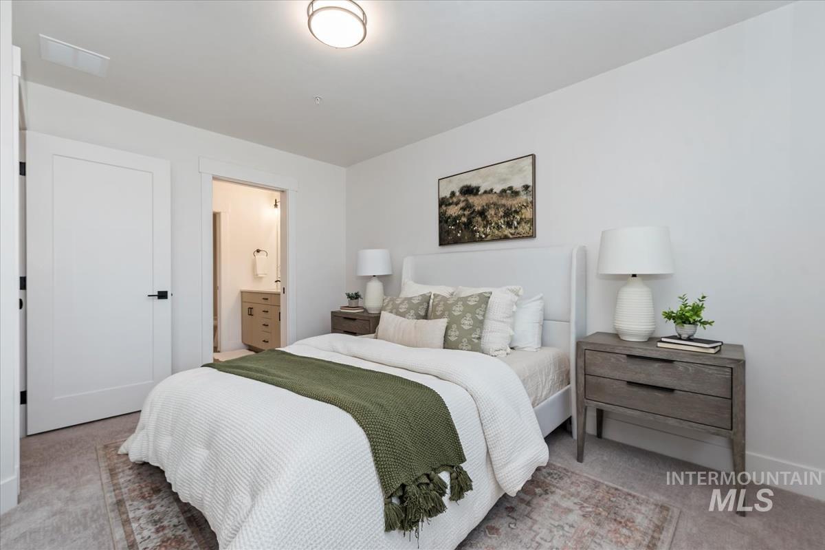 Bedroom featuring carpet and ensuite bath