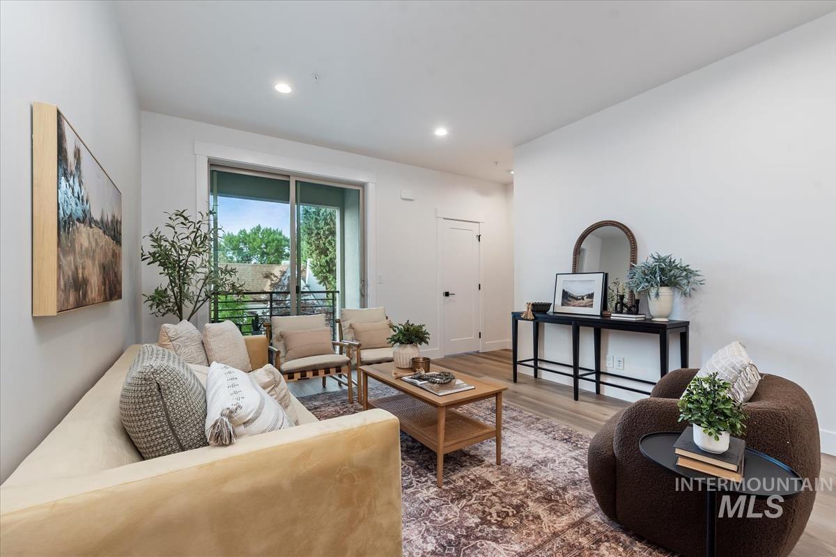 Living room featuring wood finished floors and recessed lighting