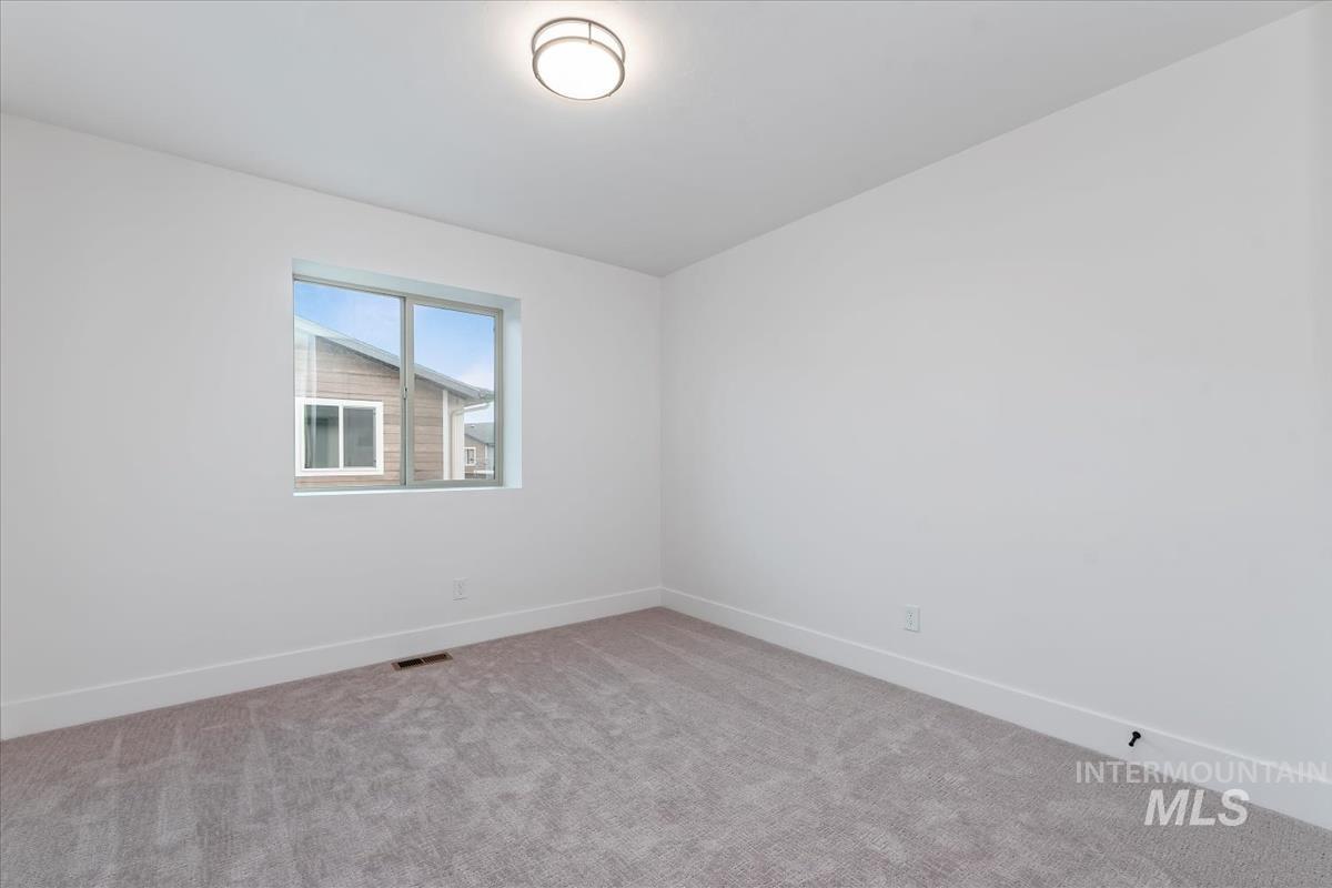 Unfurnished room featuring carpet flooring and baseboards