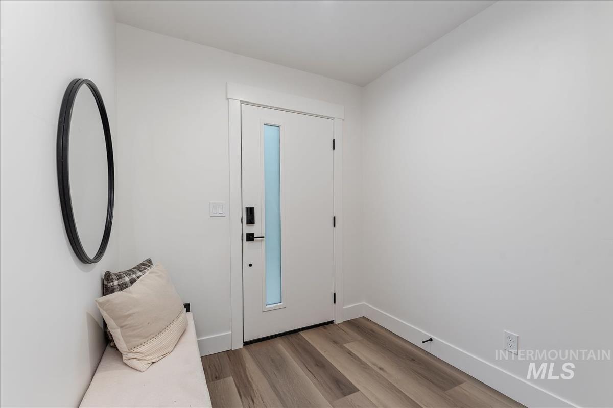 Entrance foyer with light wood finished floors and baseboards