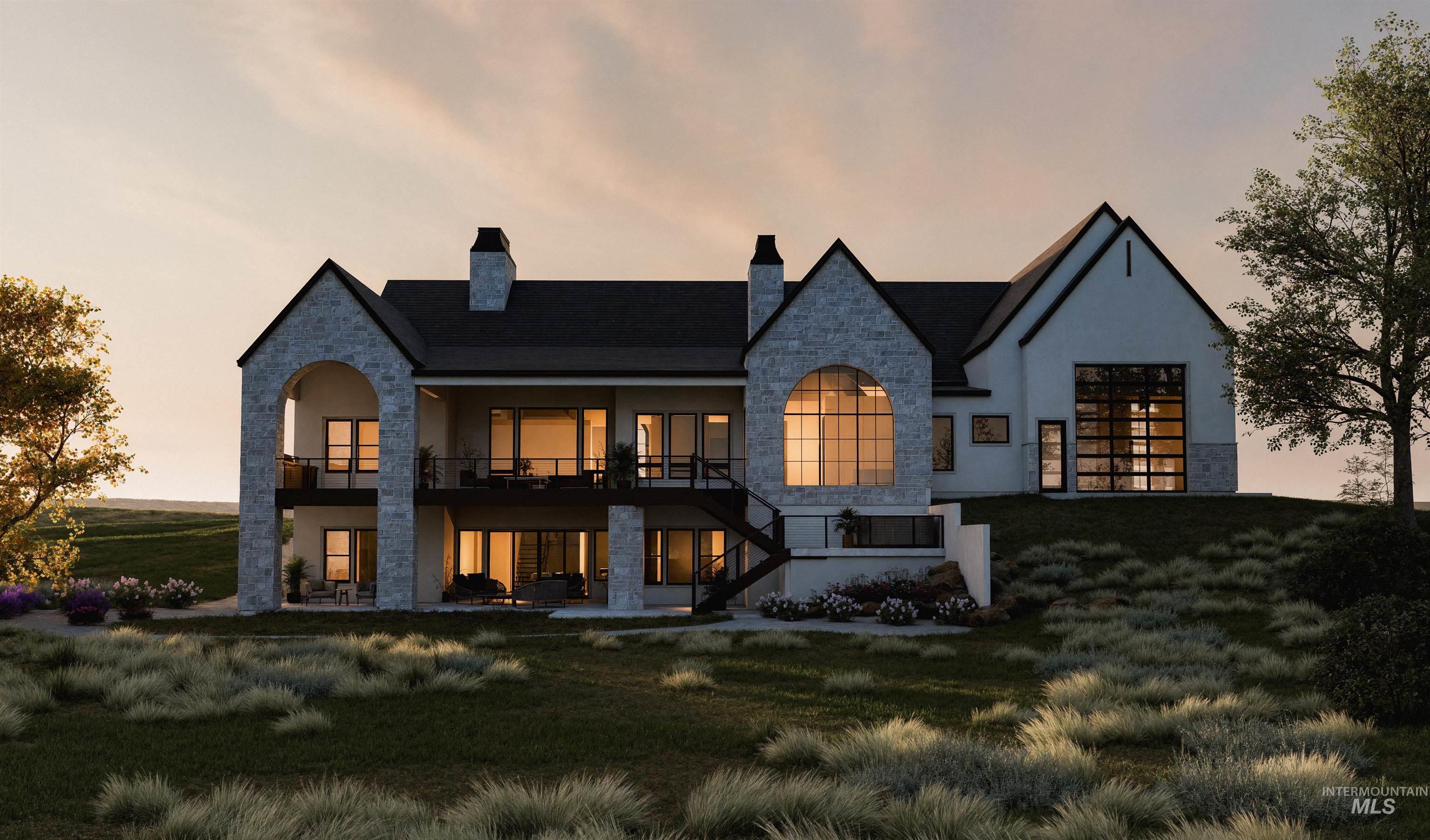 Rear view of property featuring stone siding, stairs, a yard, a chimney, and a balcony