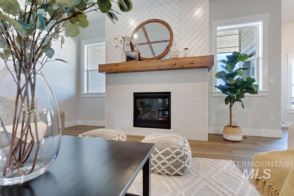 Living area with a tile fireplace and wood finished floors