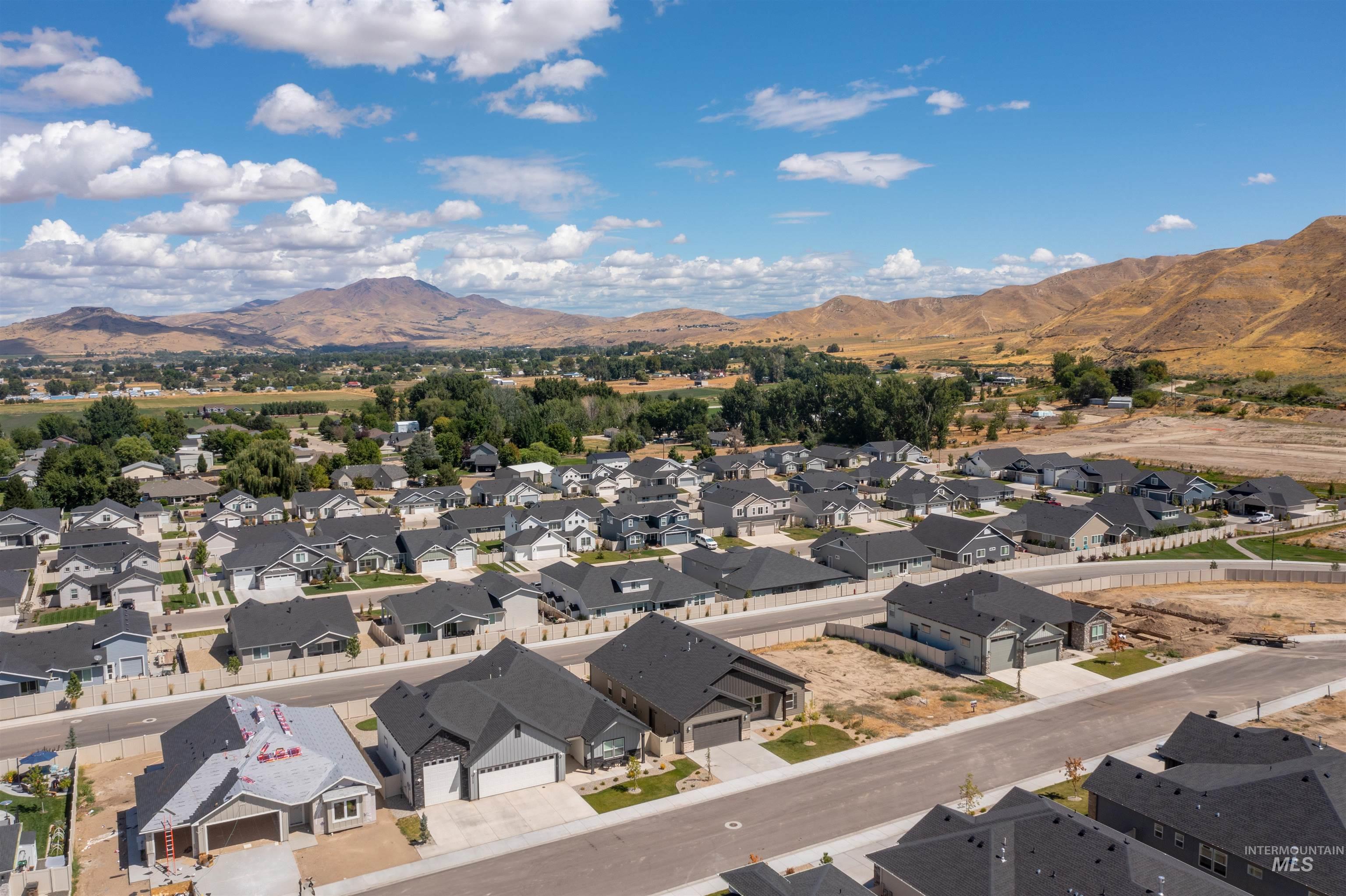 Aerial perspective of suburban area featuring a mountainous background