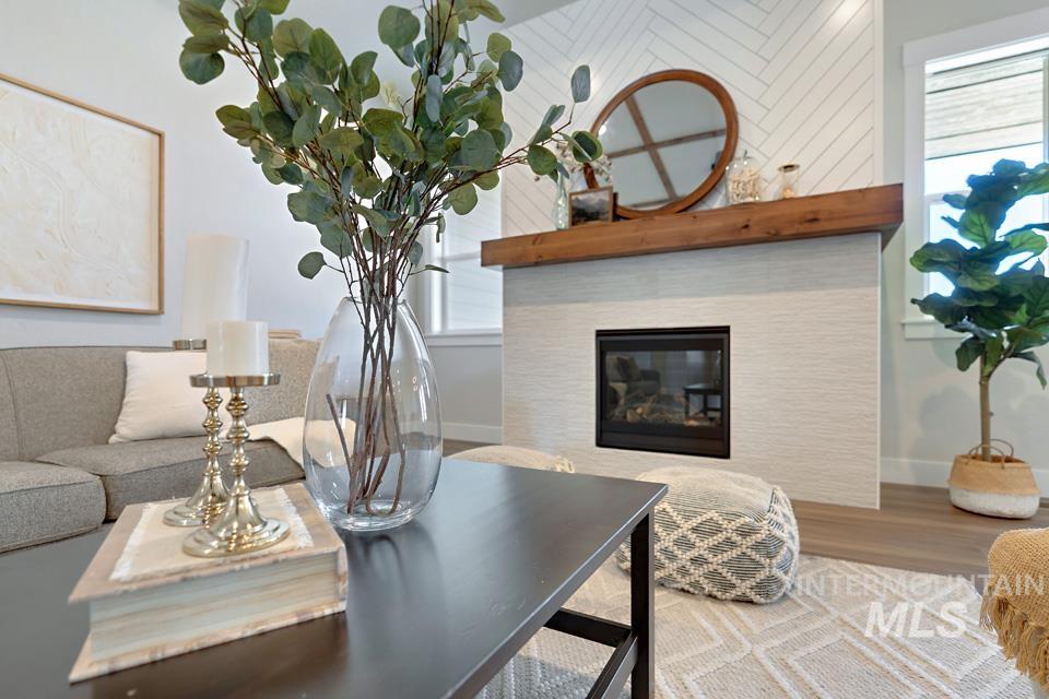 Living area with a fireplace and wood finished floors