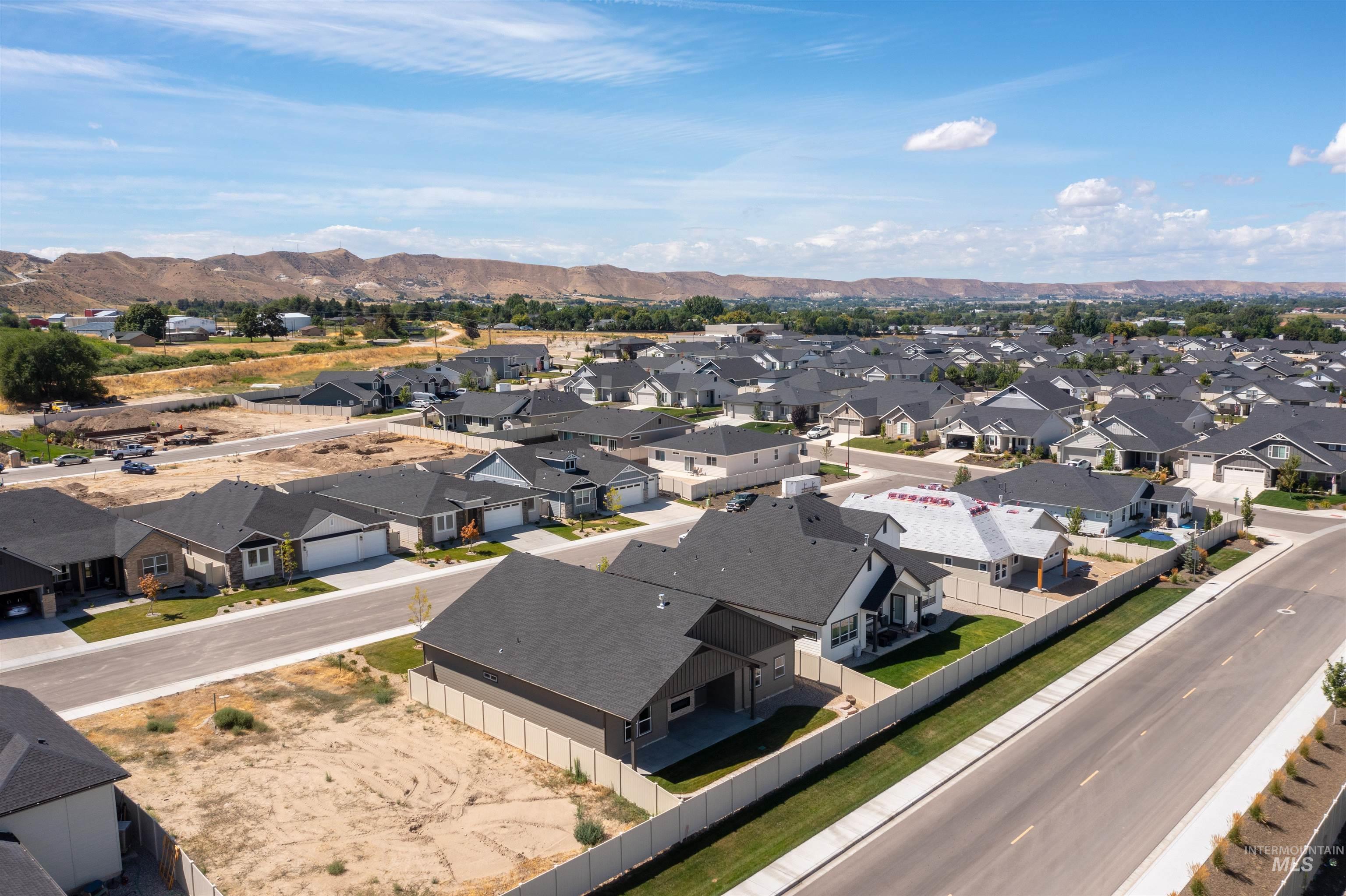 Aerial view of residential area featuring a mountainous background