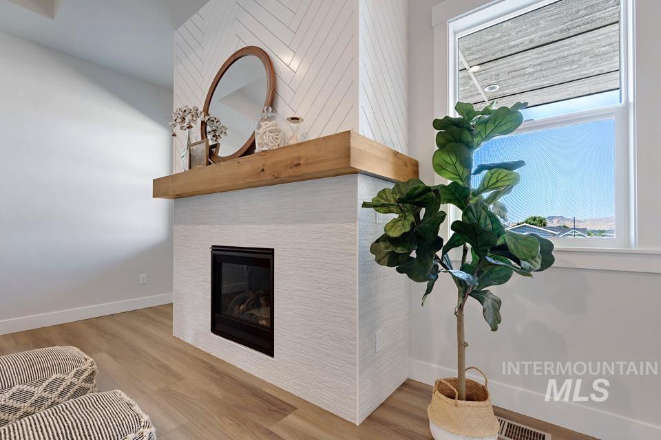 Detailed view of a fireplace and wood finished floors