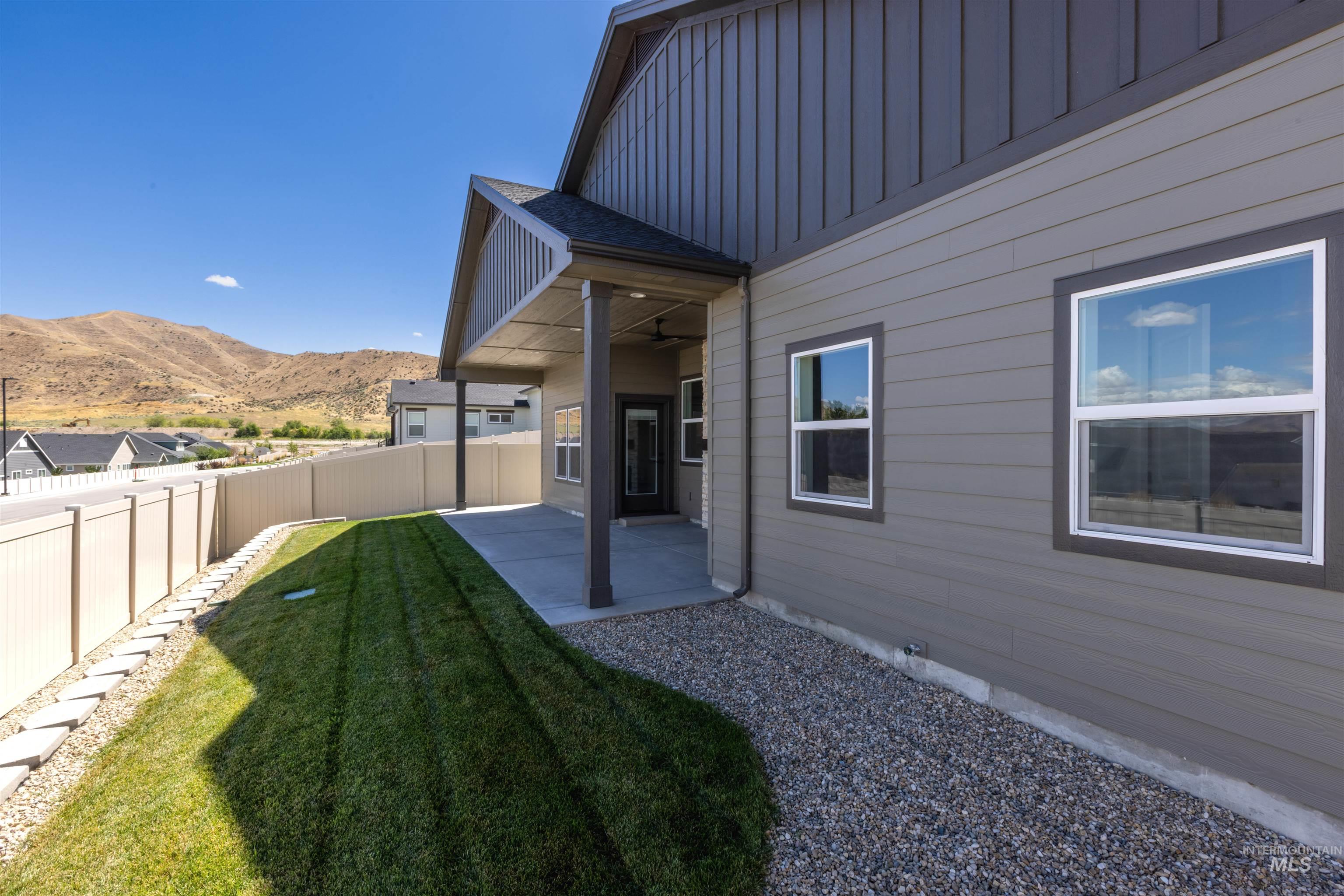 Fenced backyard with a patio area and a mountain view
