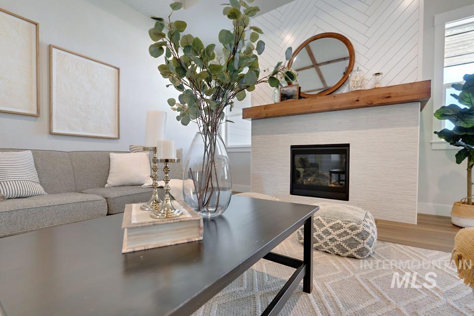 Living area featuring a tile fireplace and wood finished floors
