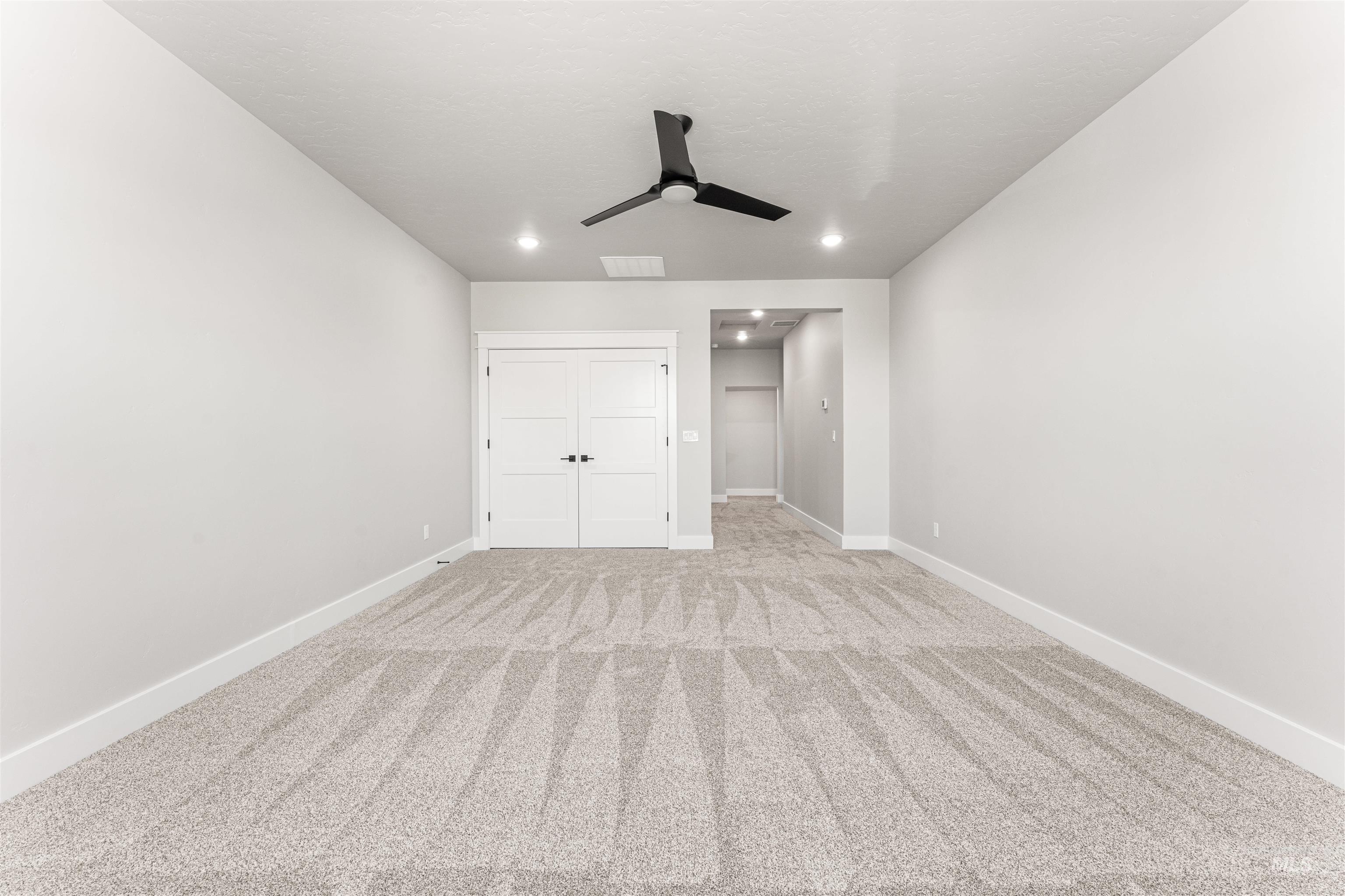 Unfurnished bedroom featuring recessed lighting, light carpet, a closet, and a ceiling fan