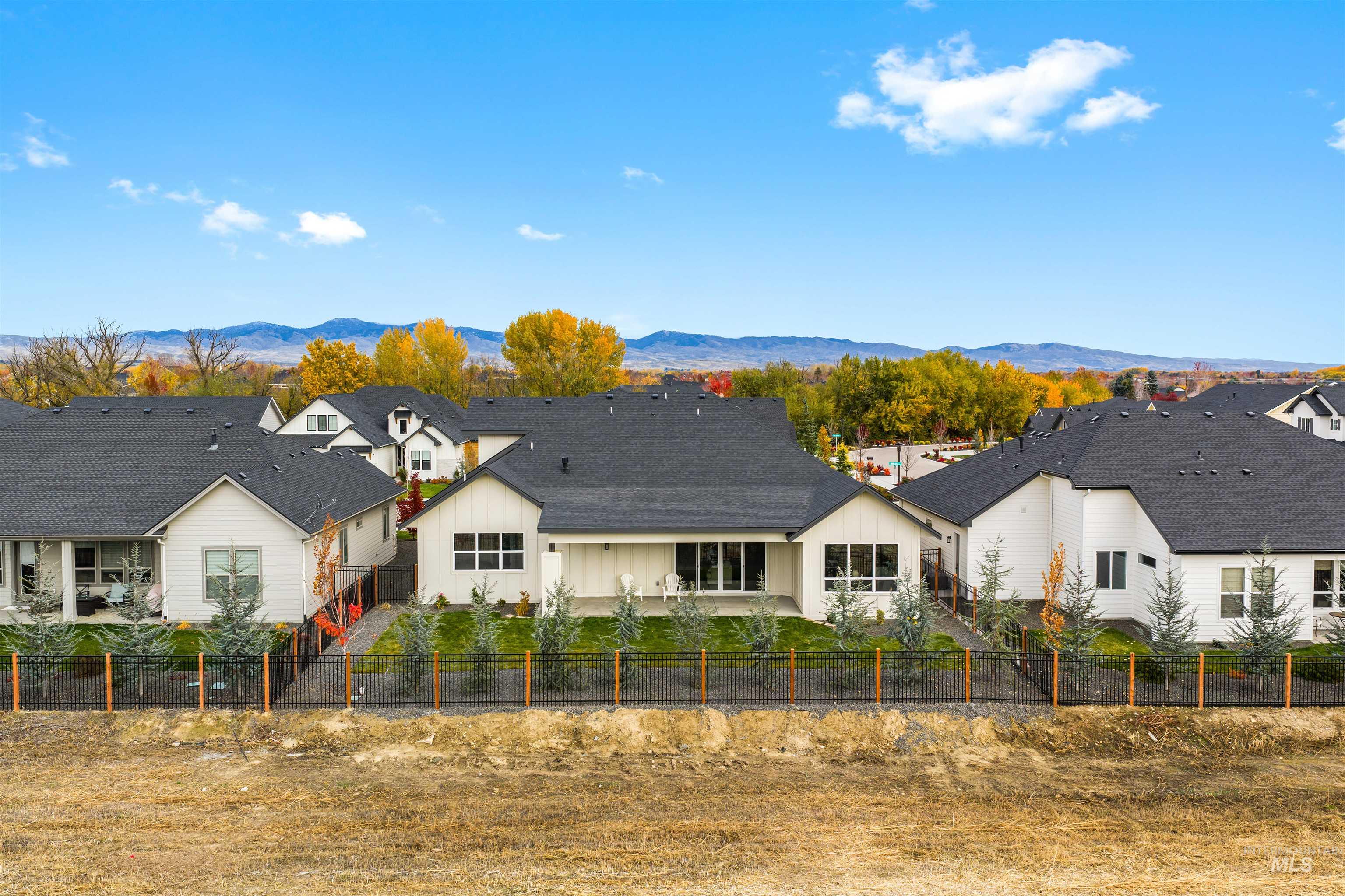 Rear view of property featuring a mountain view, board and batten siding, and a residential view