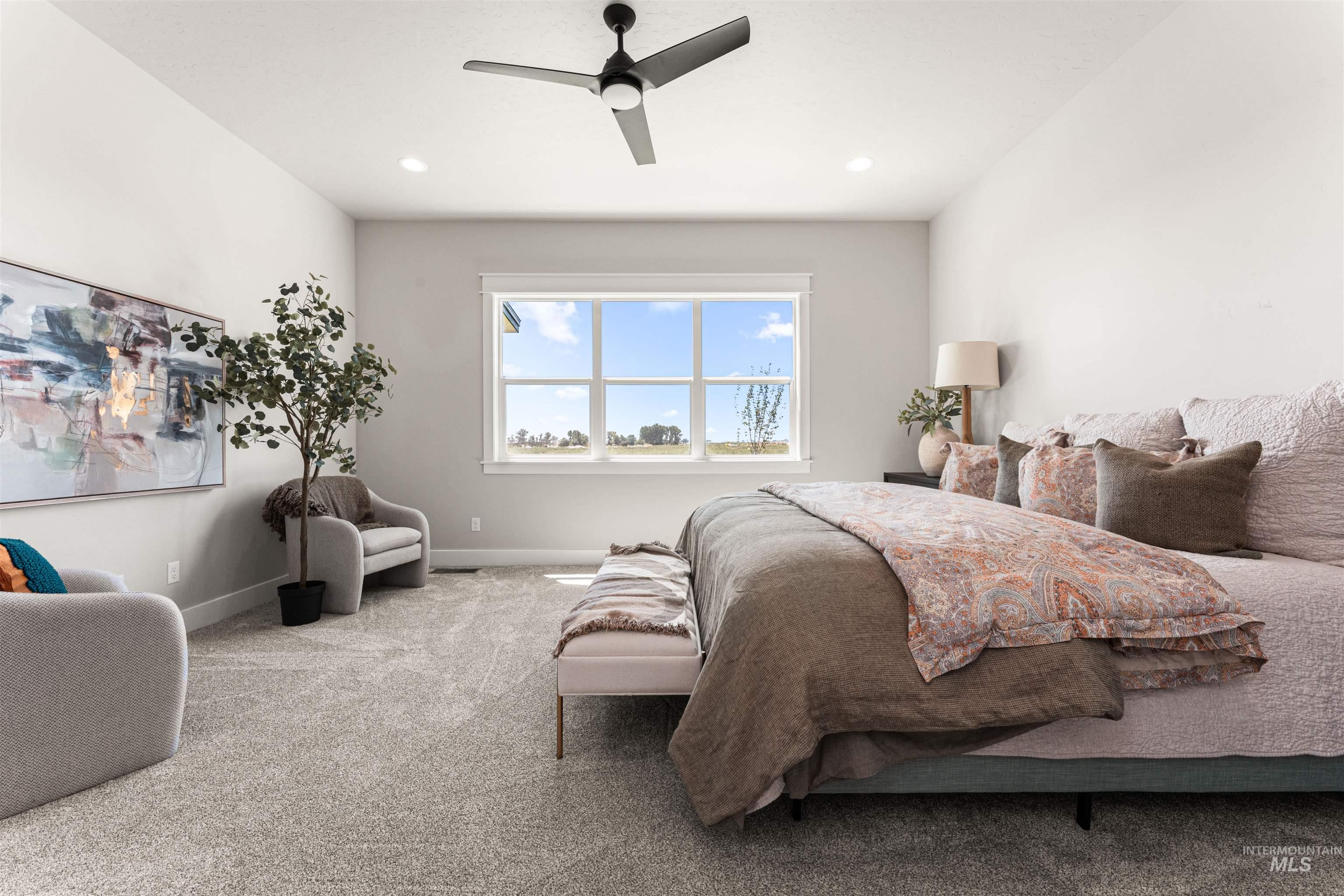 Carpeted bedroom with a ceiling fan and recessed lighting