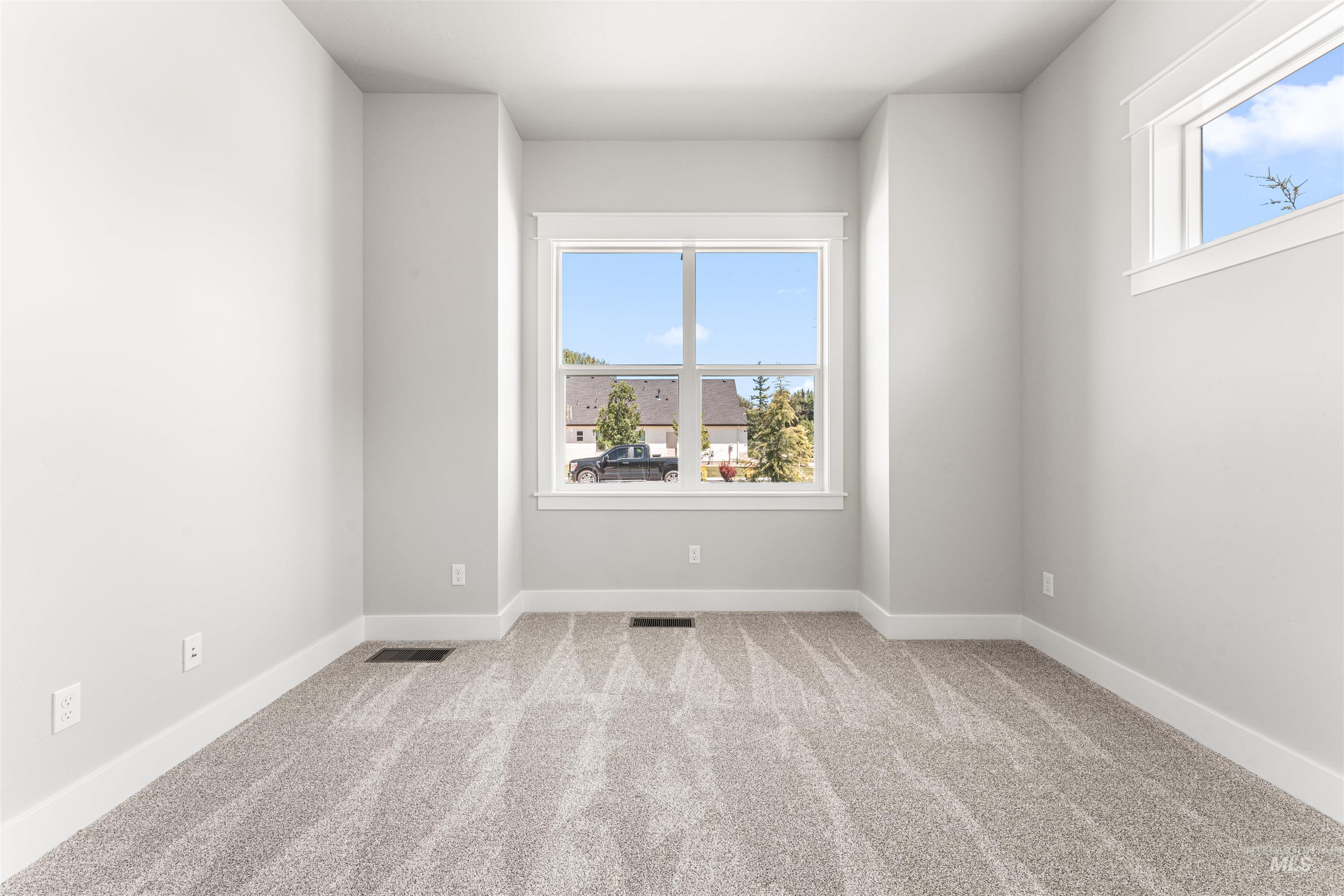 Spare room with carpet floors and baseboards