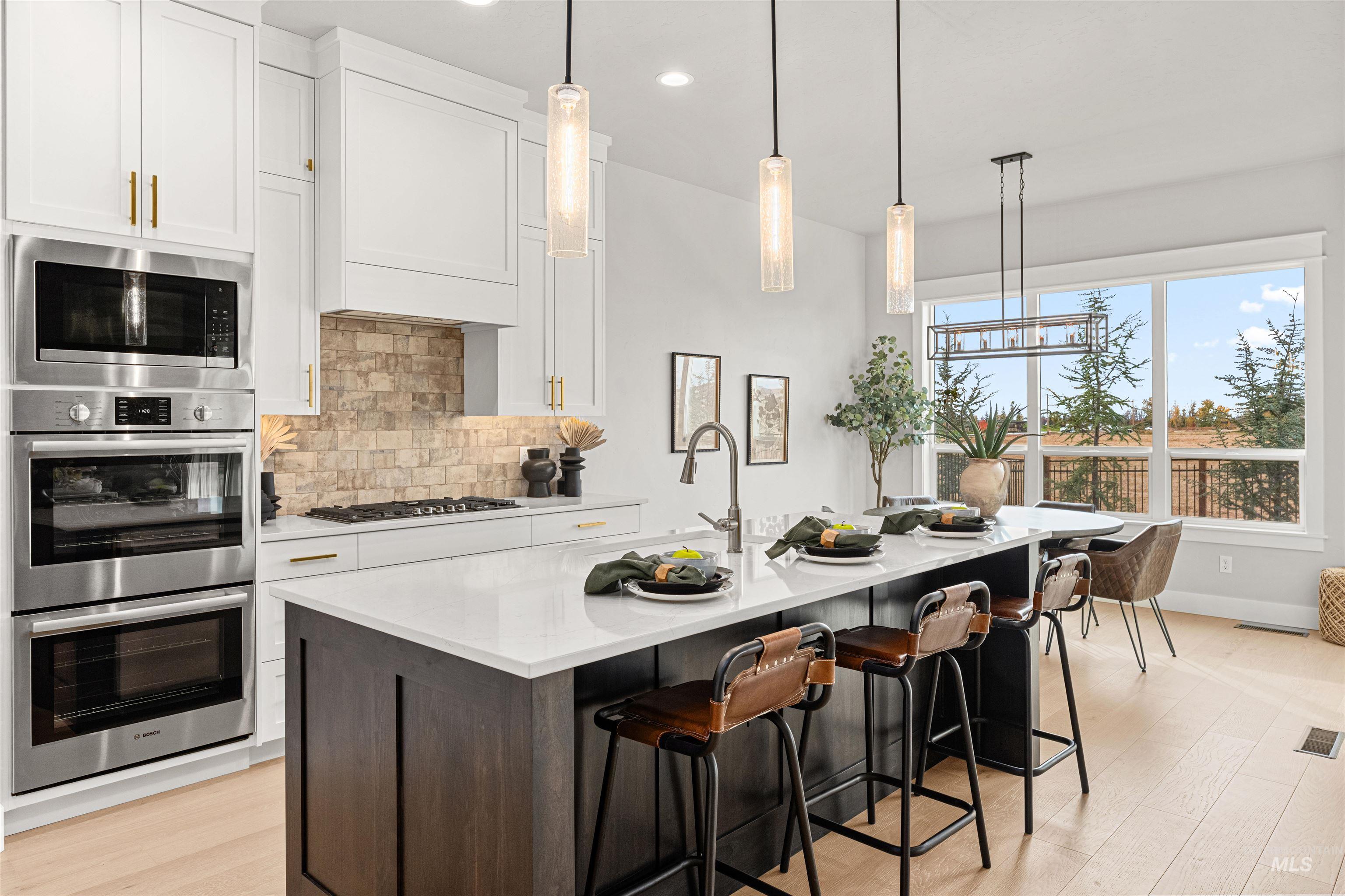 Kitchen featuring decorative backsplash, stainless steel appliances, light wood-type flooring, white cabinets, and recessed lighting