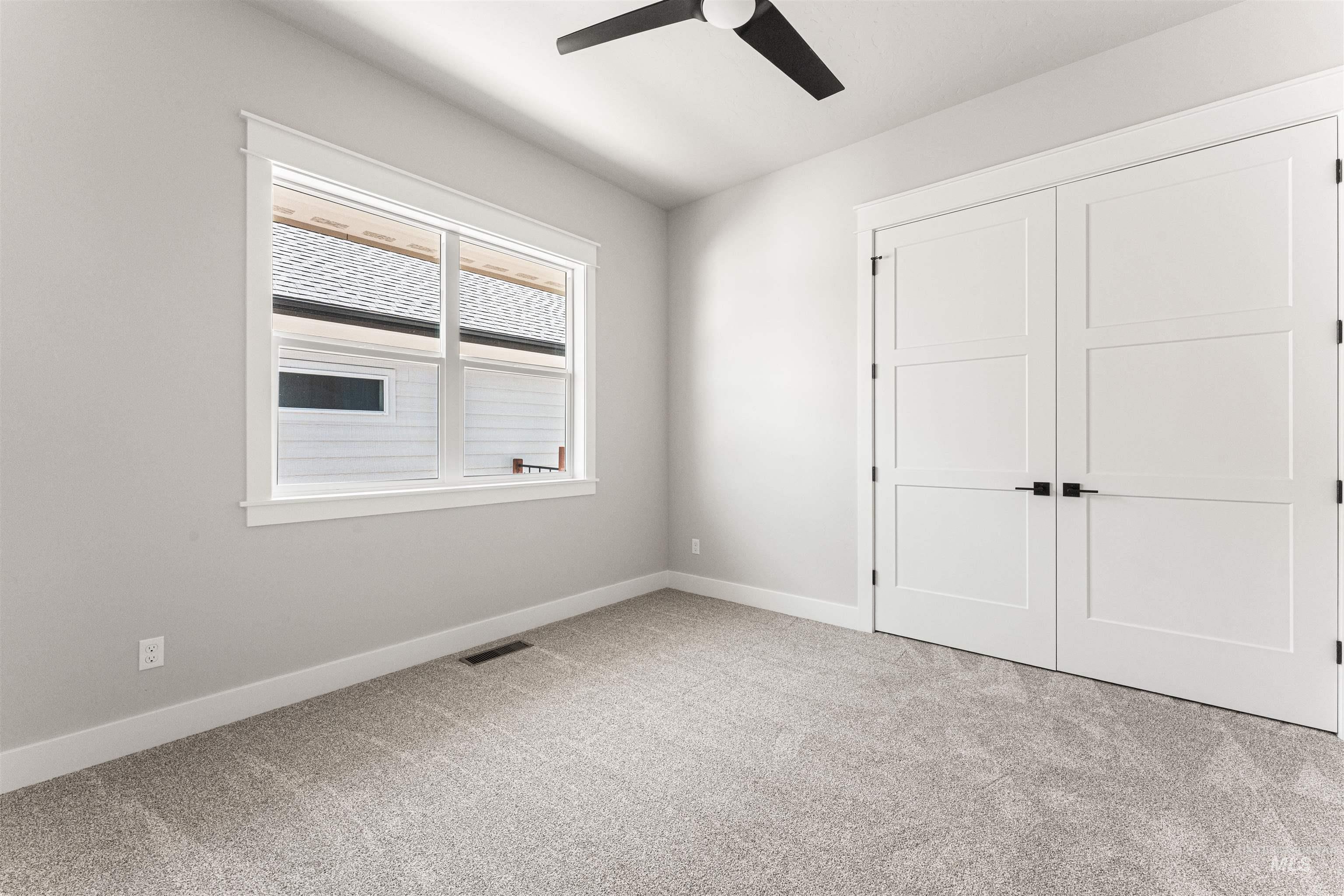 Unfurnished bedroom featuring carpet, a closet, and ceiling fan