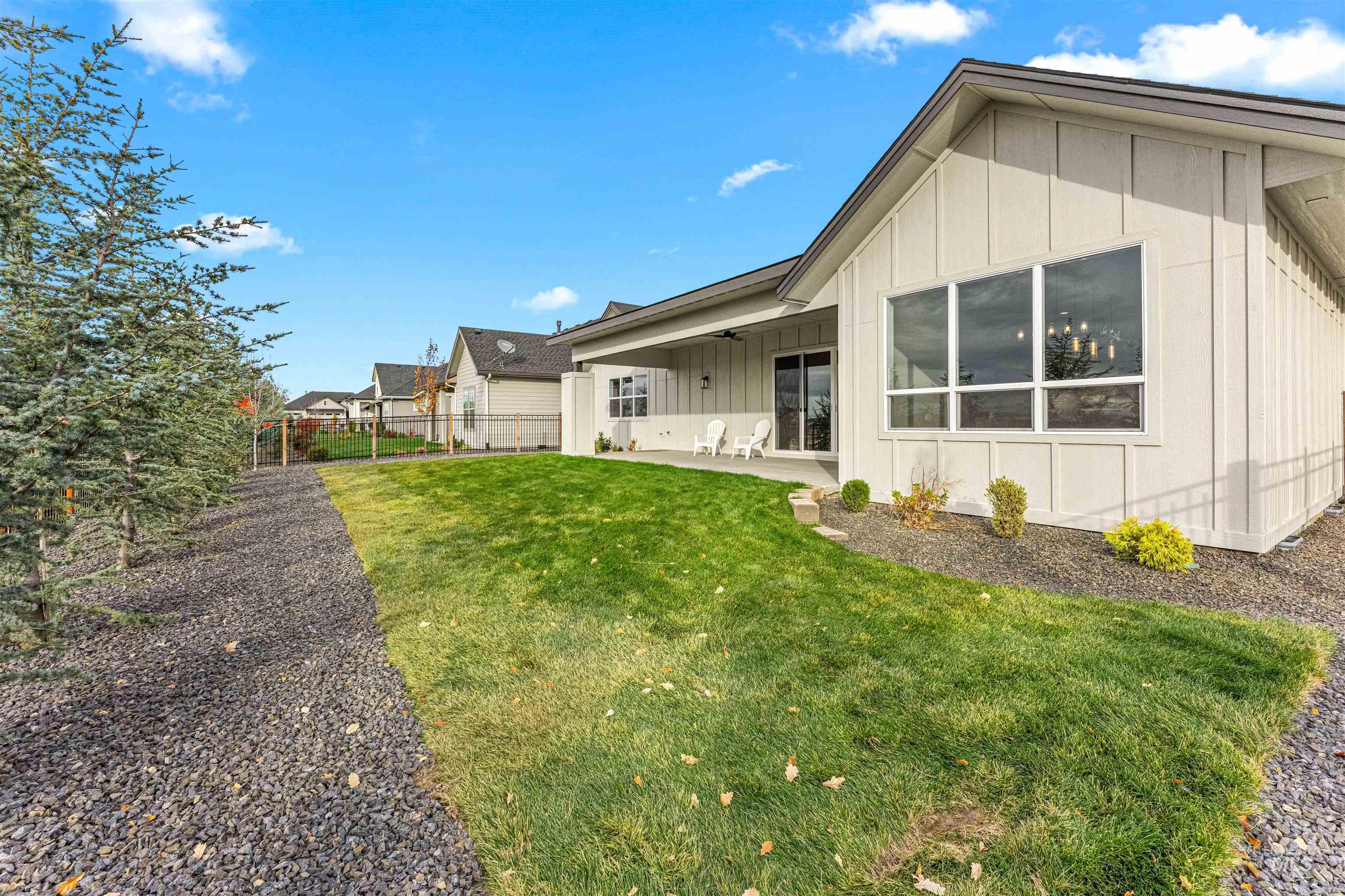 Back of property featuring board and batten siding and a patio area
