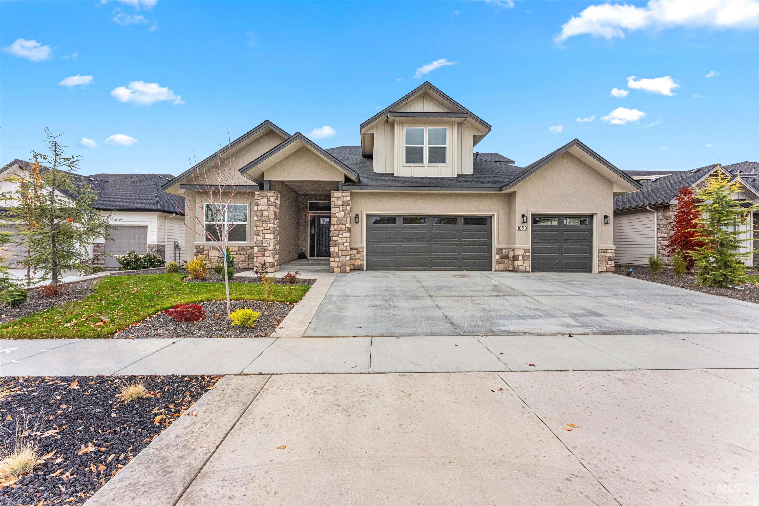 Craftsman inspired home featuring stone siding, concrete driveway, an attached garage, and stucco siding